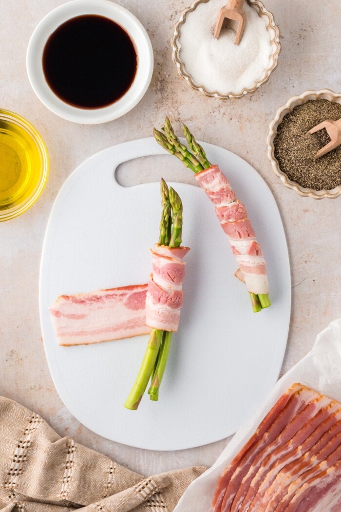 Bundles of asparagus wrapped in a slice of bacon