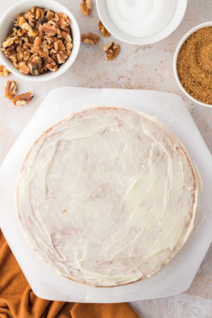 A thin layer of cream cheese frosting on a carrot cake