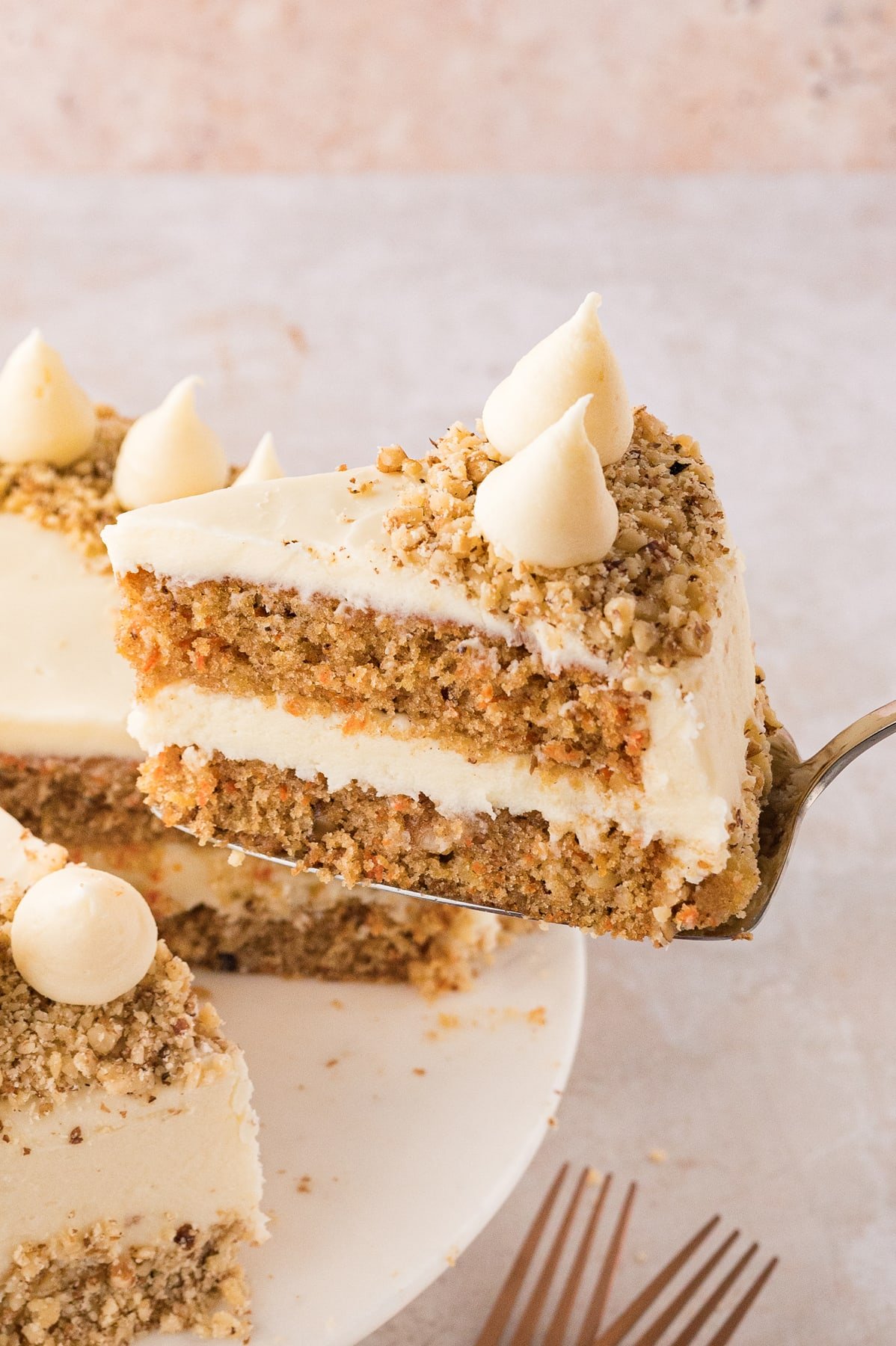 A slice of carrot cake being served