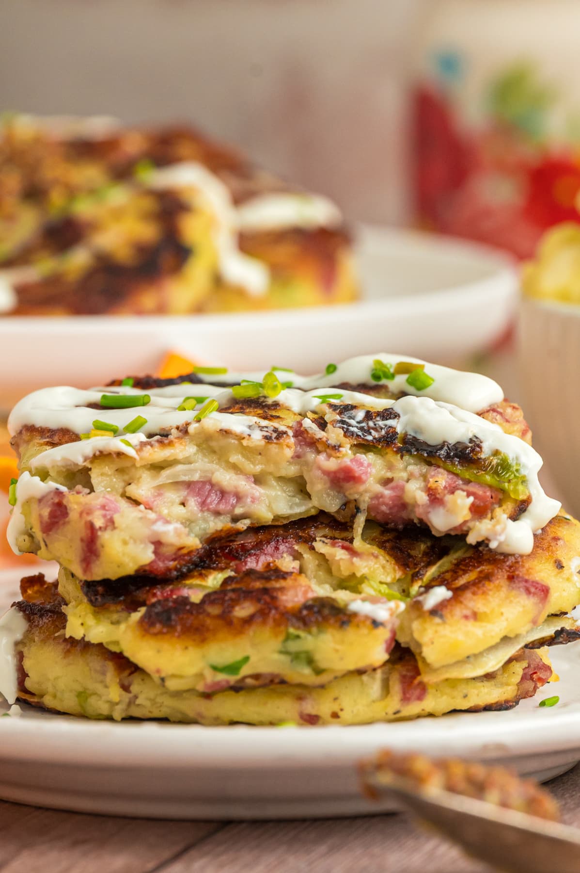colcannon cakes stacked on white plate