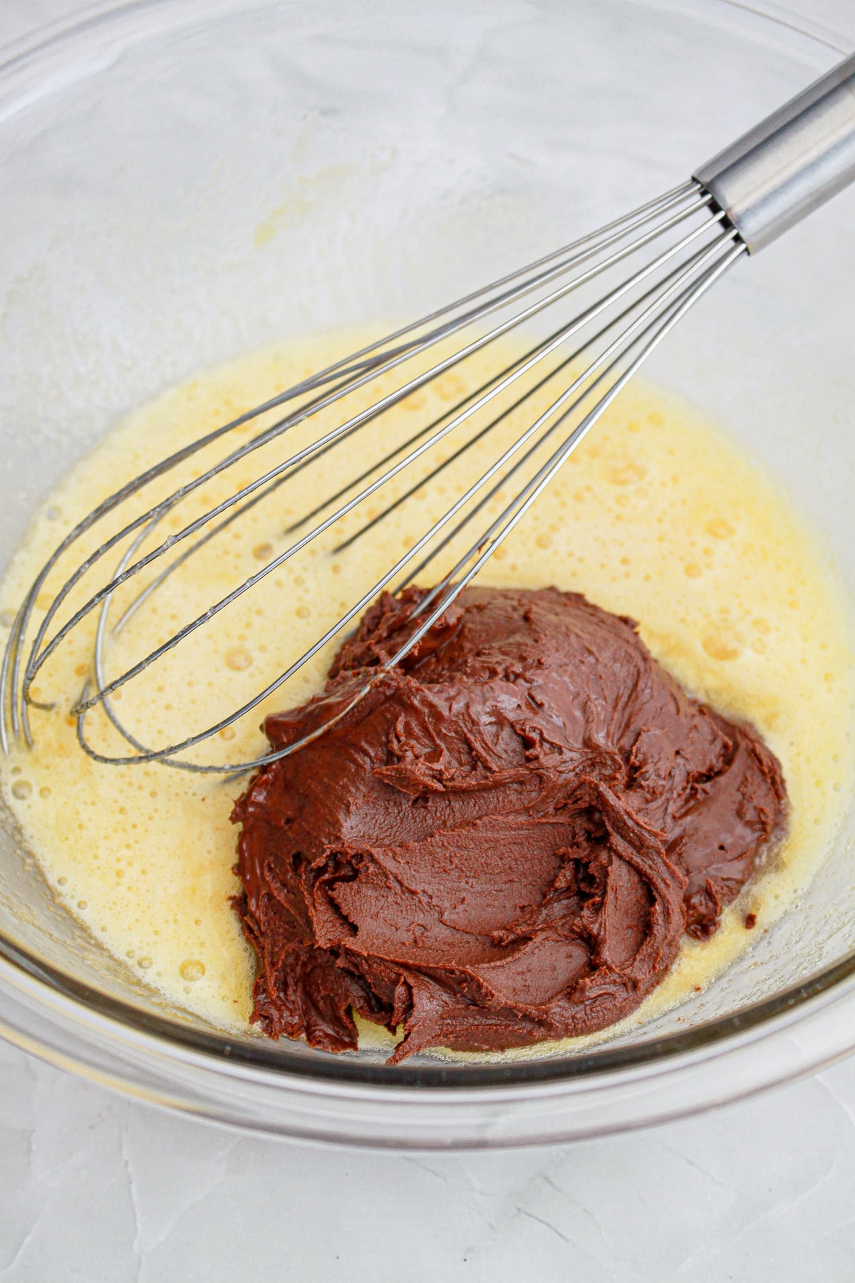wet ingredients with melted chocolate in mixing bowl