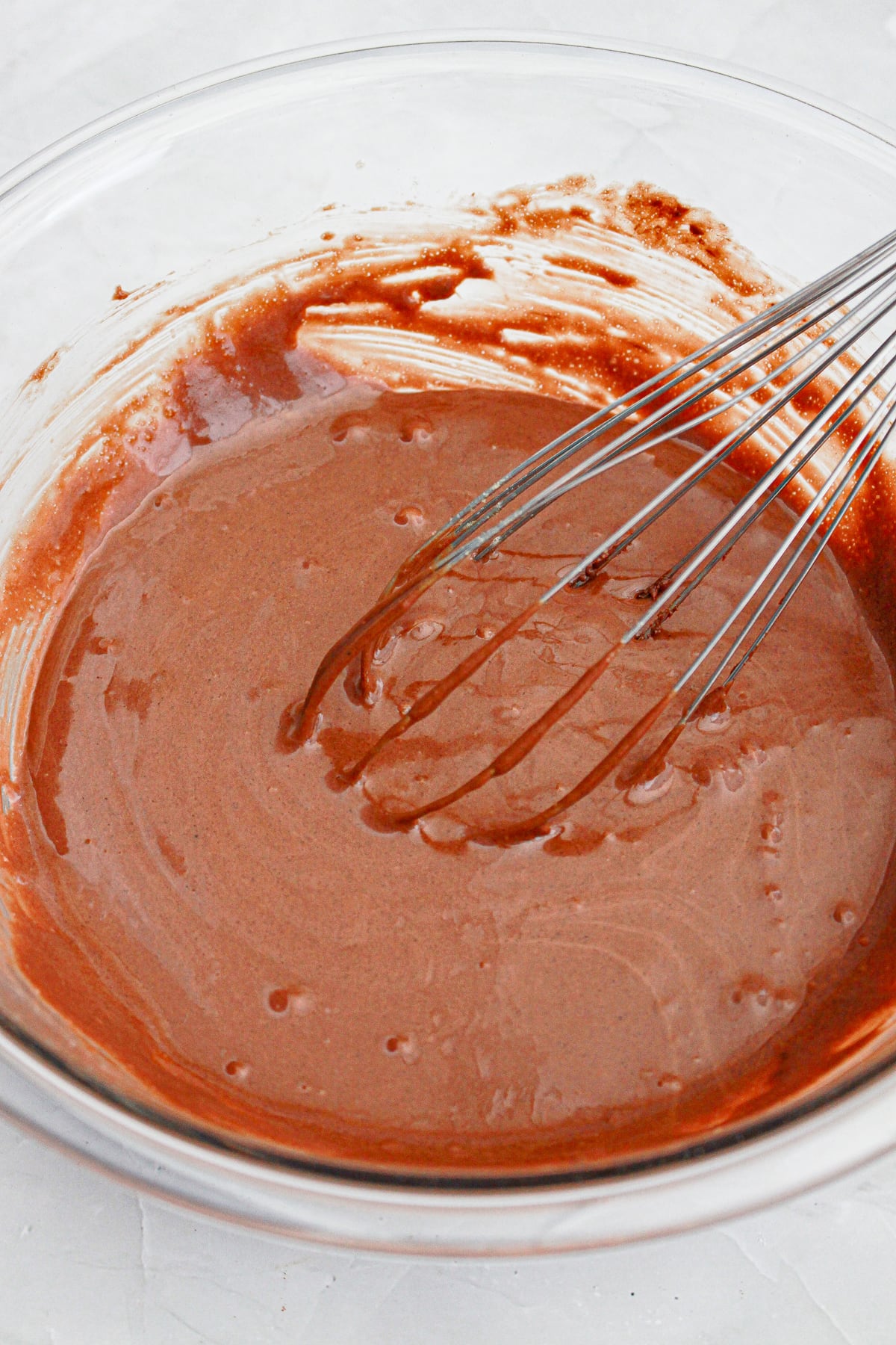 German chocolate cookie batter in mixing bowl with whisk