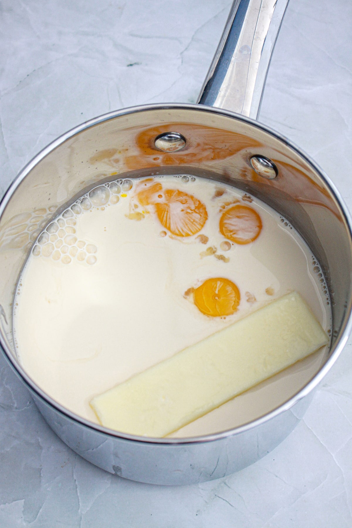 evaporated milk, butter, egg yolks, sugar and vanilla in a medium sized saucepan
