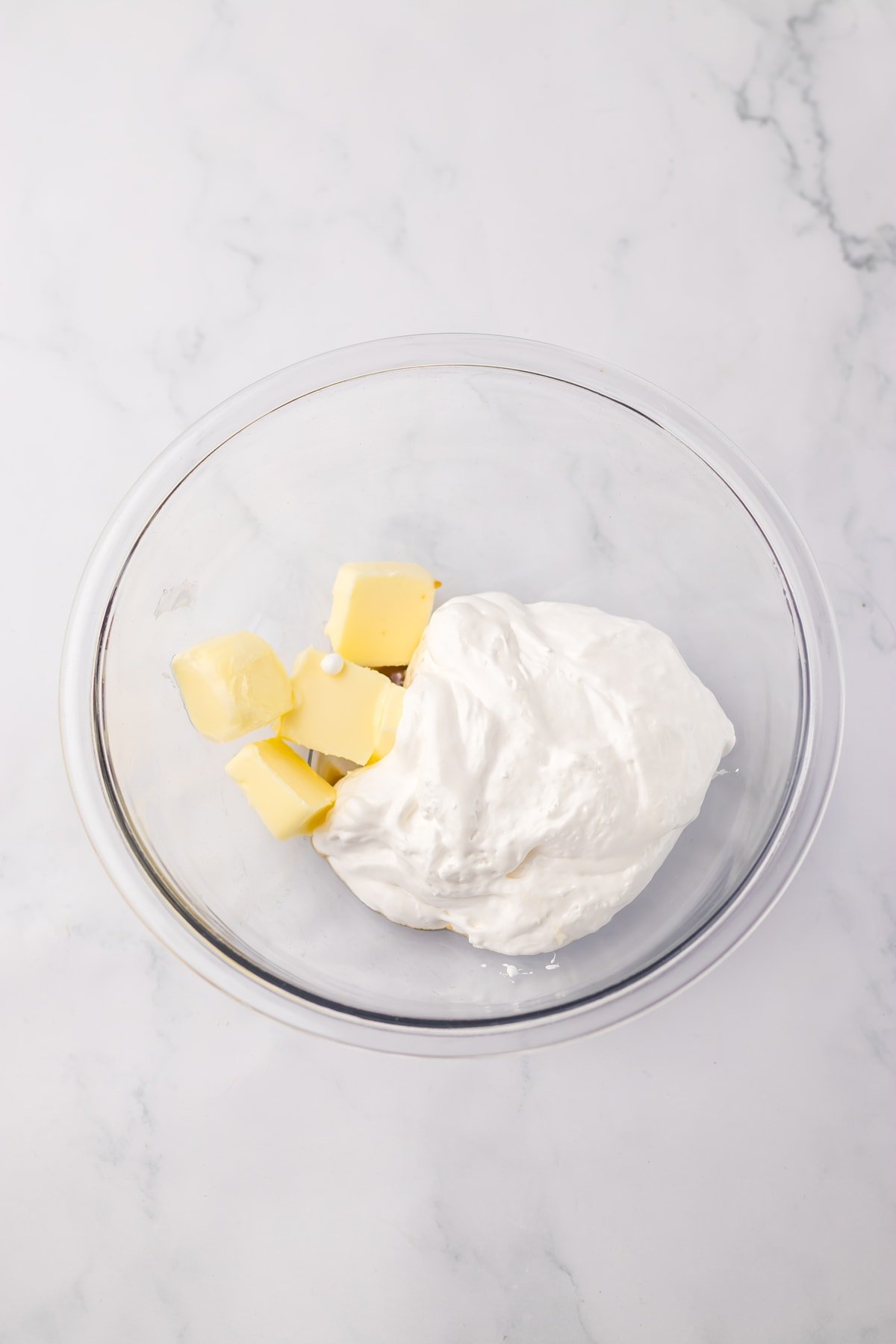 butter and marshmallow fluff in glass bowl
