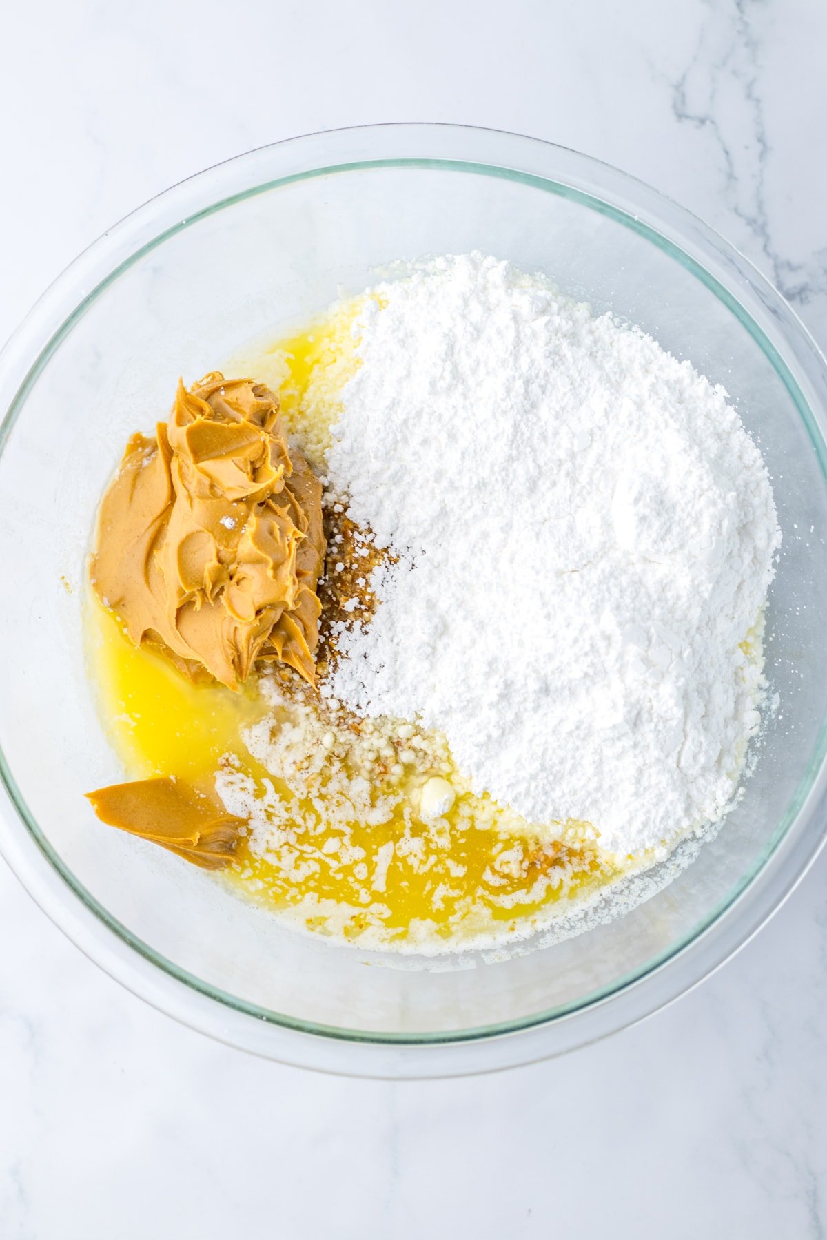 melted butter, peanut butter, and powdered sugar in mixing bowl