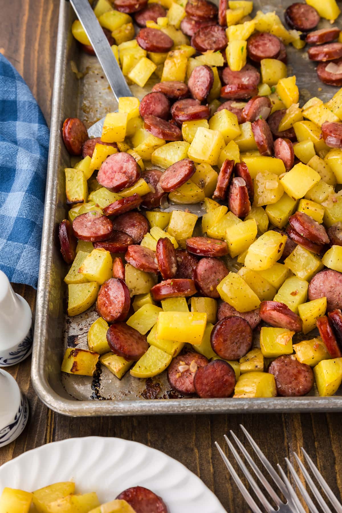 sausage and potatoes on a sheet baking pan