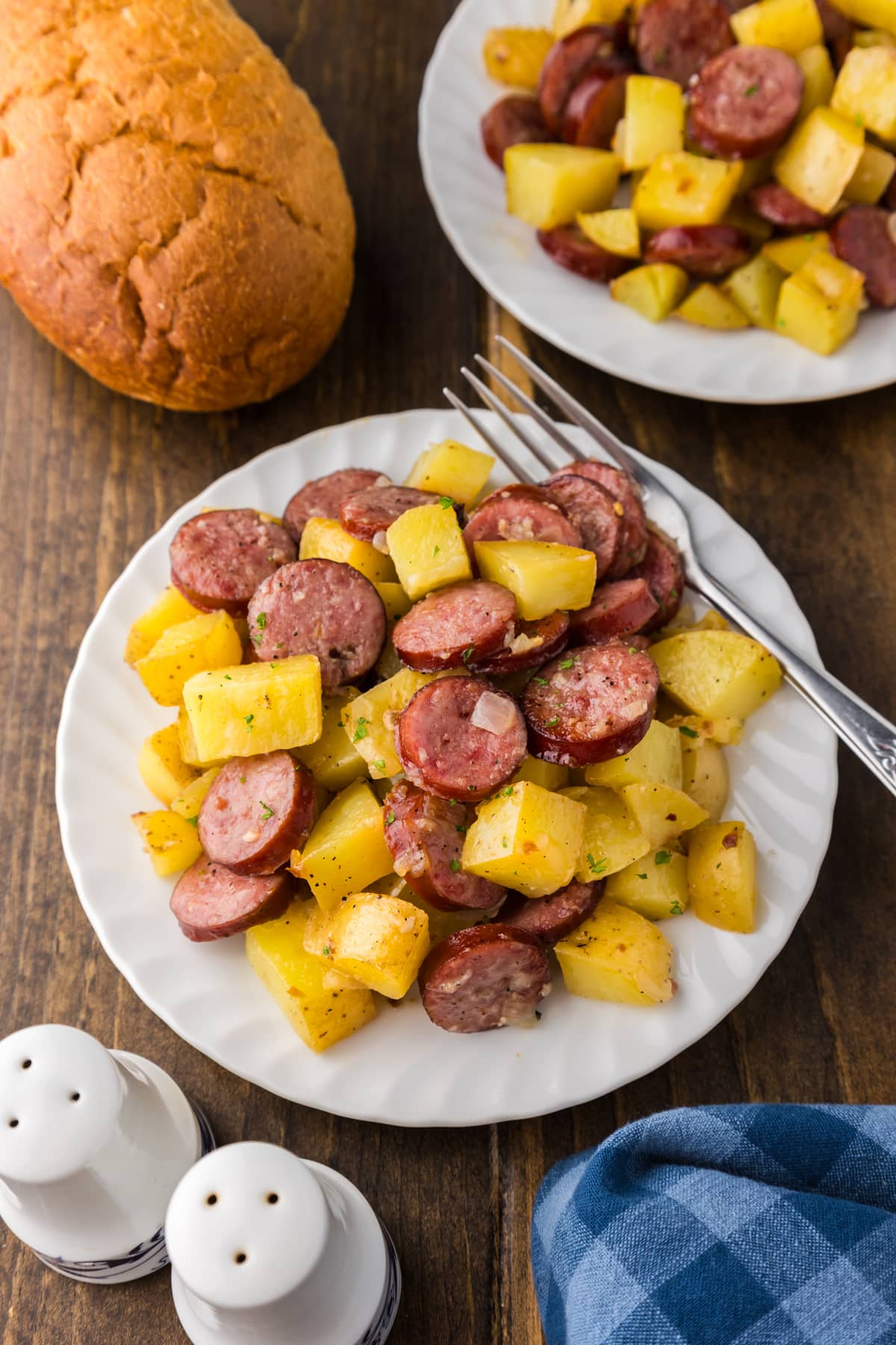 sausage and potatoes on white plate with bread