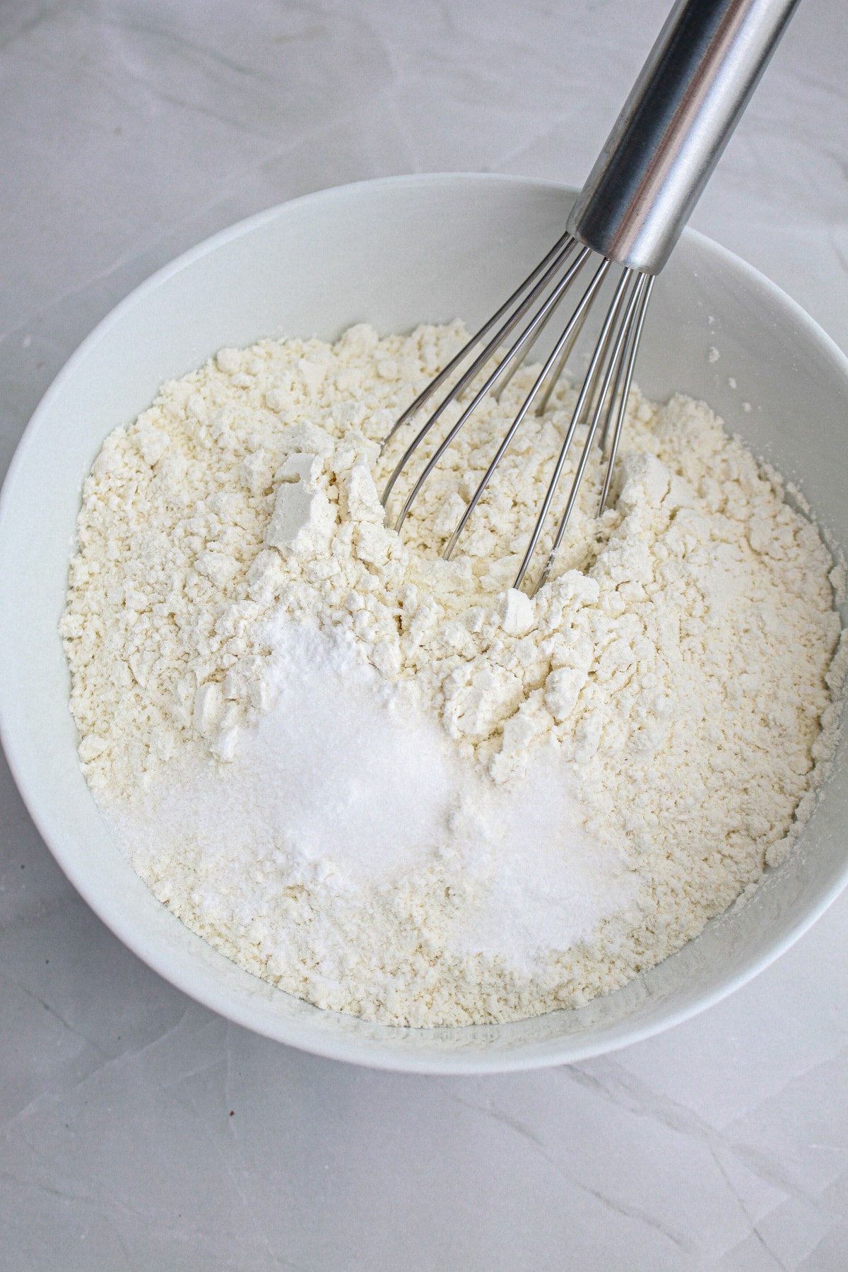 flour and dry ingredients in bowl with whisk