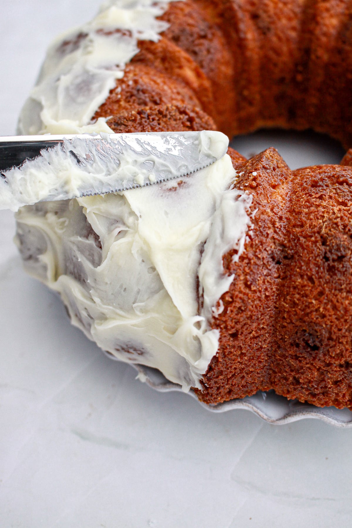 frosting spread on White Chocolate Coconut Bundt Cake