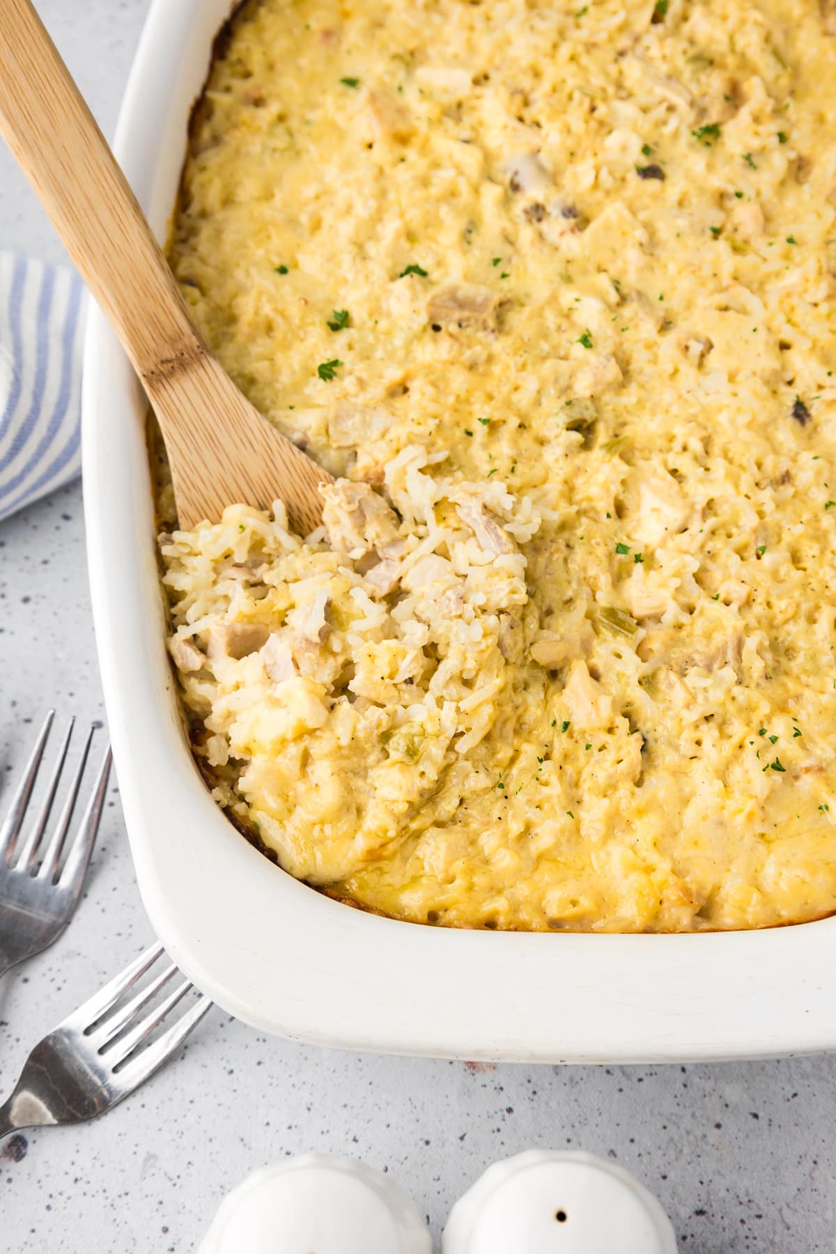 chicken and rice casserole with wooden spoon