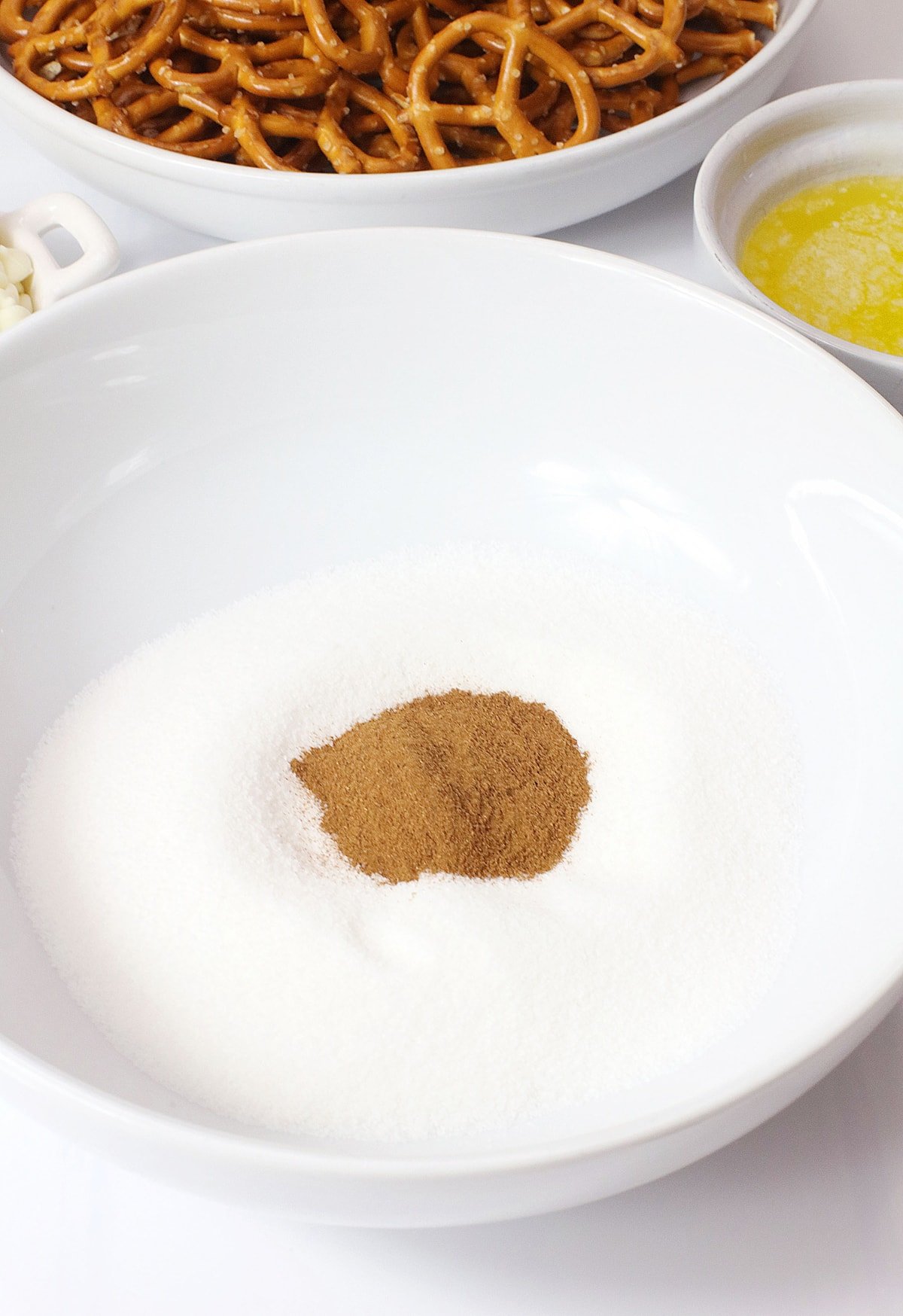 Cinnamon and sugar in a white bowl.