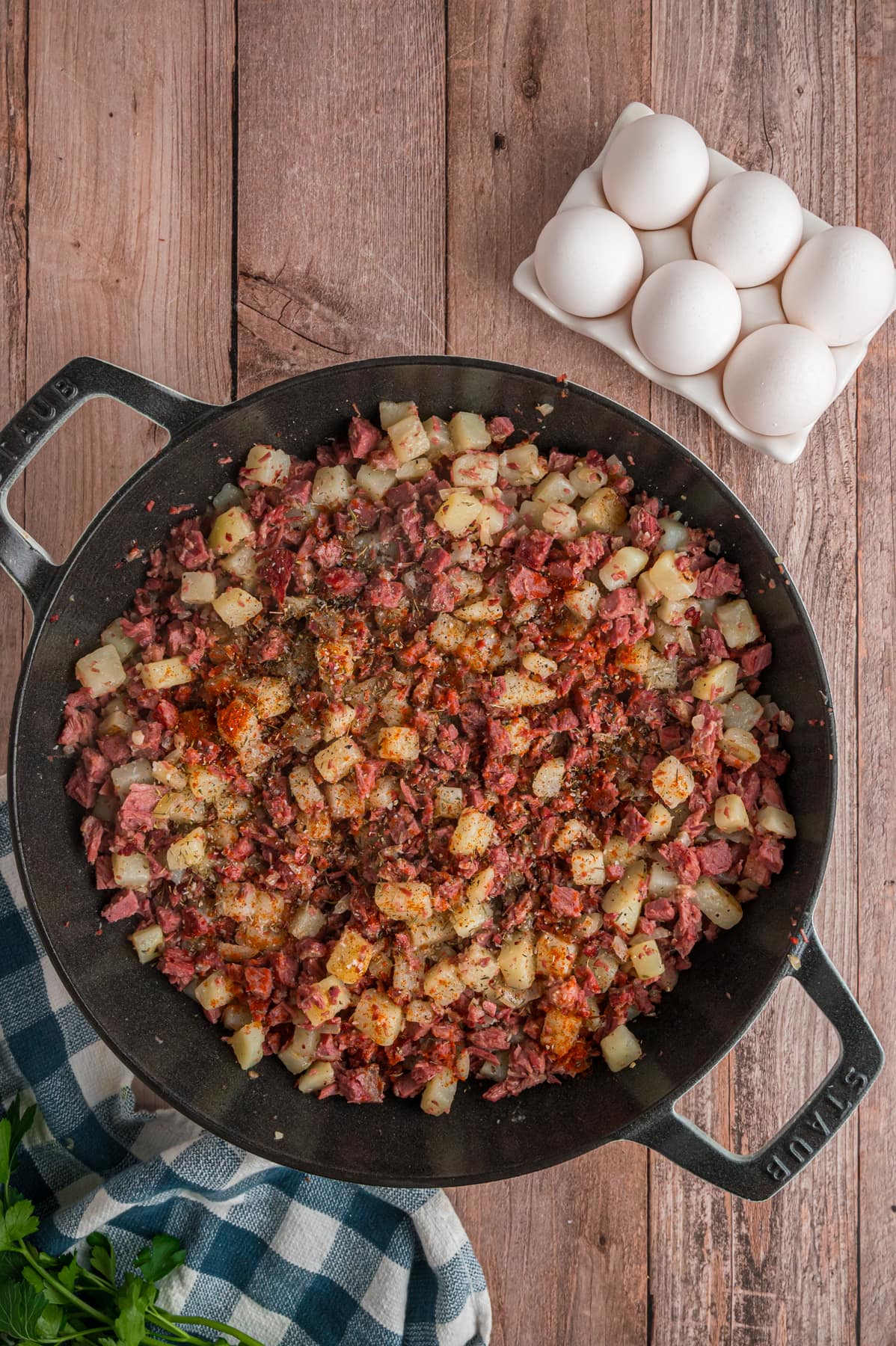 Diced potatoes and corned beef browned in a cast iron skillet.