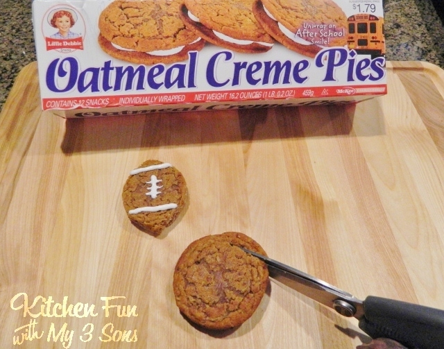 Cutting the Oatmeal Creme Football Pies with kitchen scissors