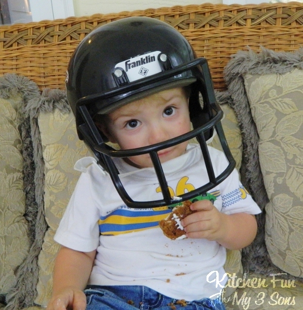 Boy with a football helmet with a oatmeal creme football pie