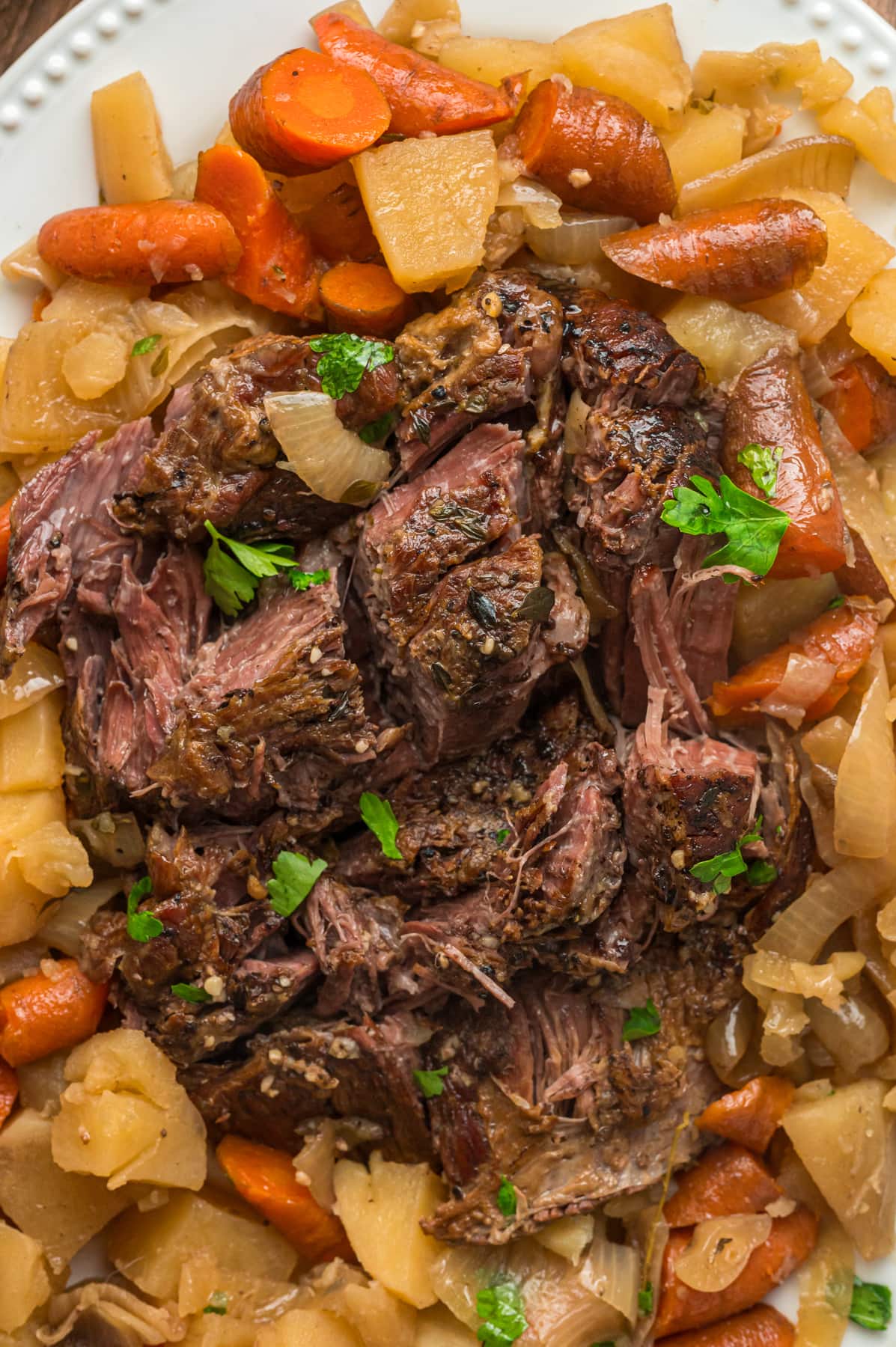 Slow cooker pot roast with potatoes and carrots on a plate