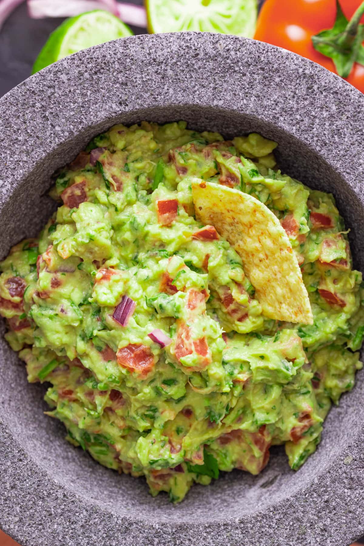 Best guacamole recipe in a bowl with a chip