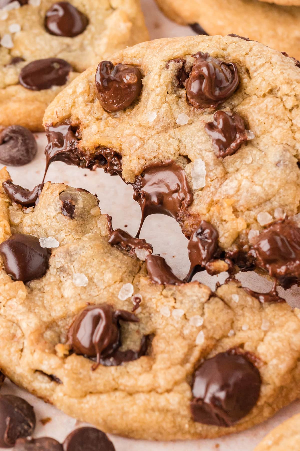 A brown butter chocolate chip cookie broken in half to show the gooey chocolate