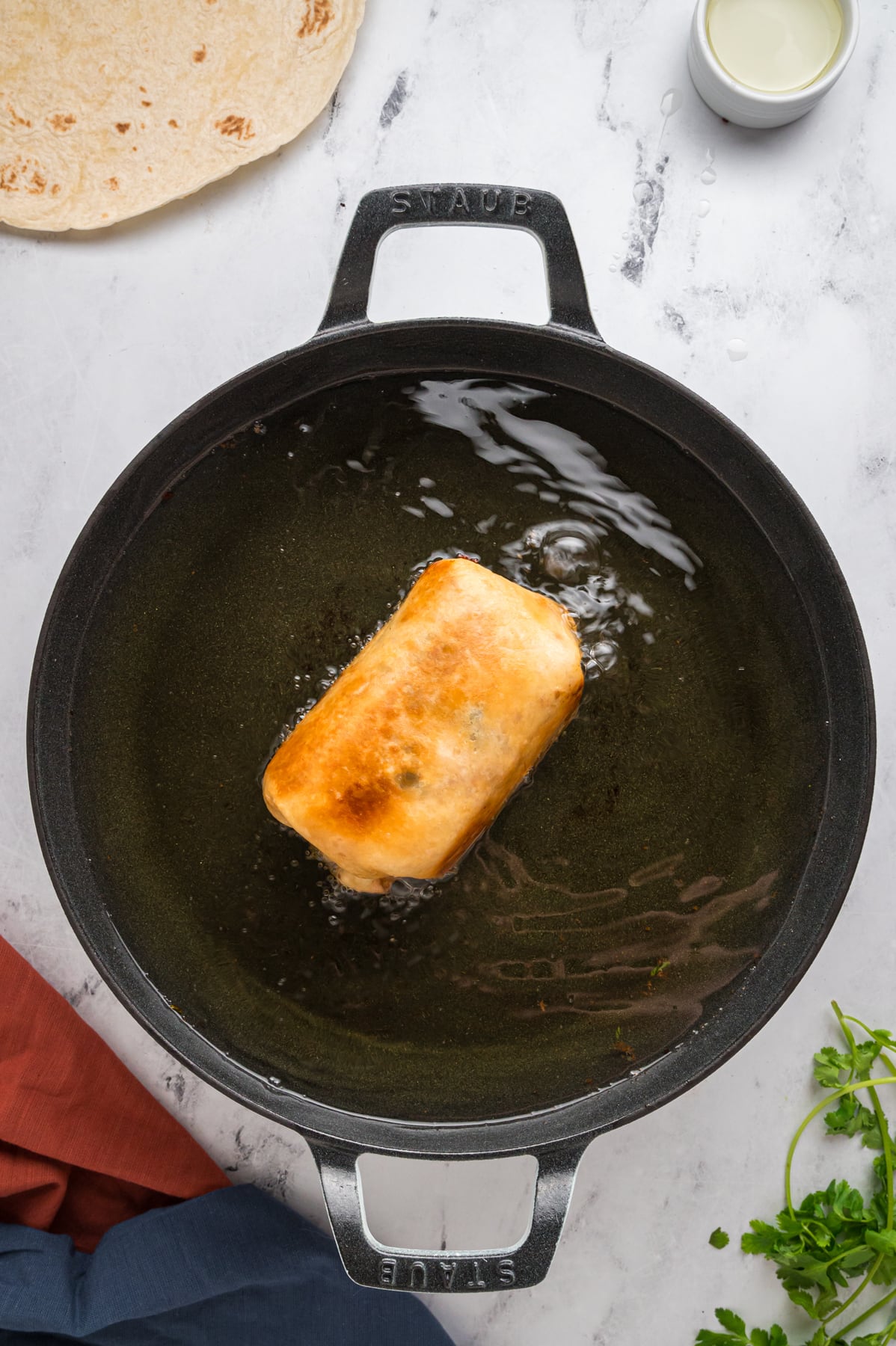 Chicken Chimichanga frying in pot