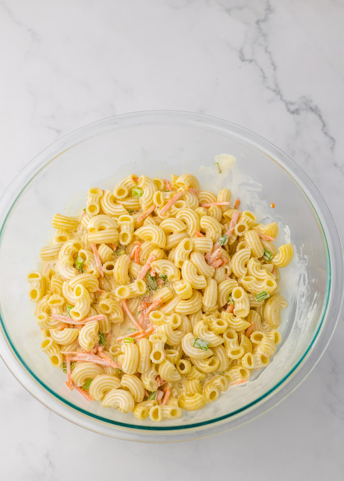 Hawaiian macaroni salad mixed in a glass bowl.