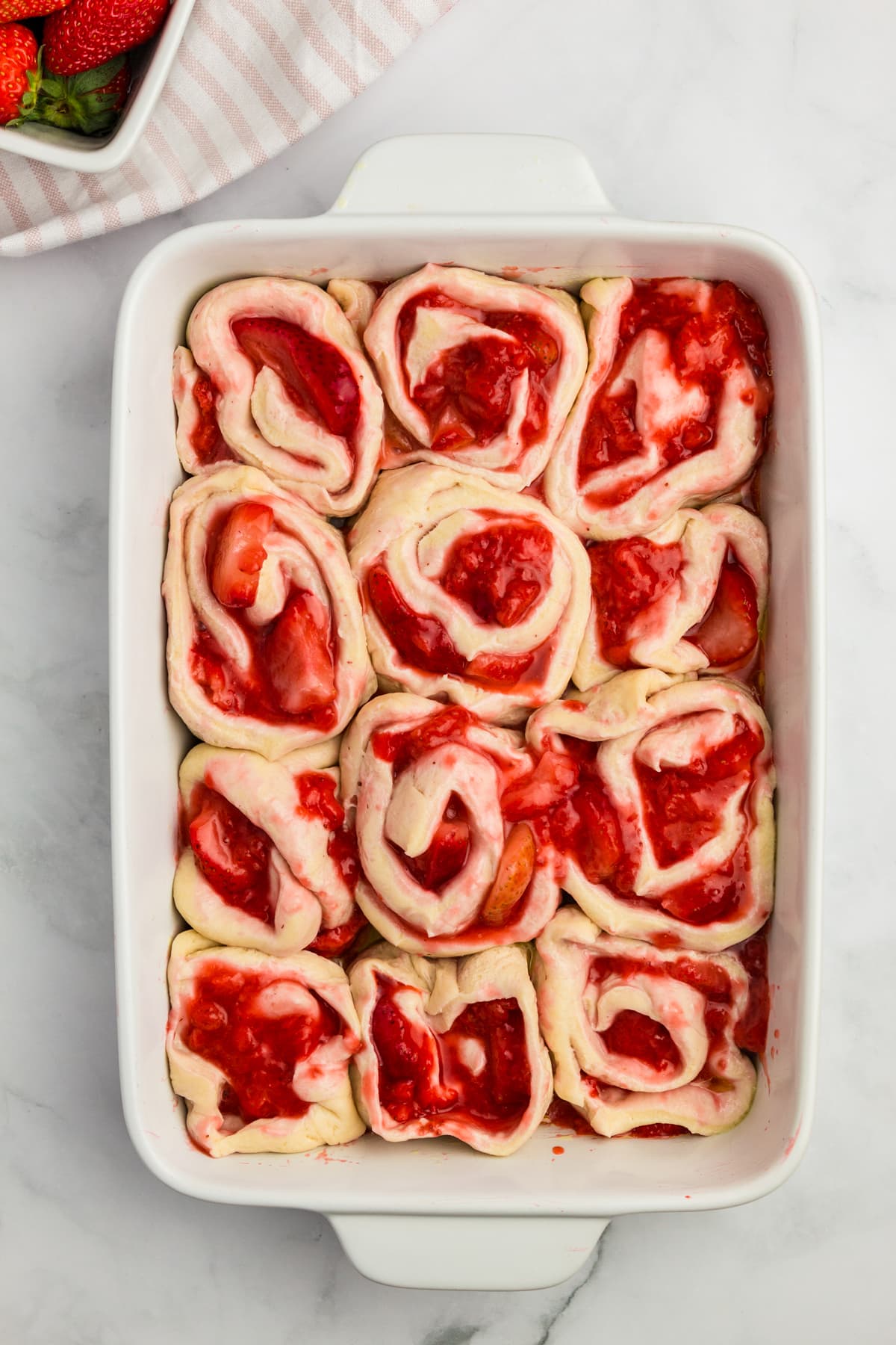 Strawberry Cinnamon Rolls in baking dish ready for oven