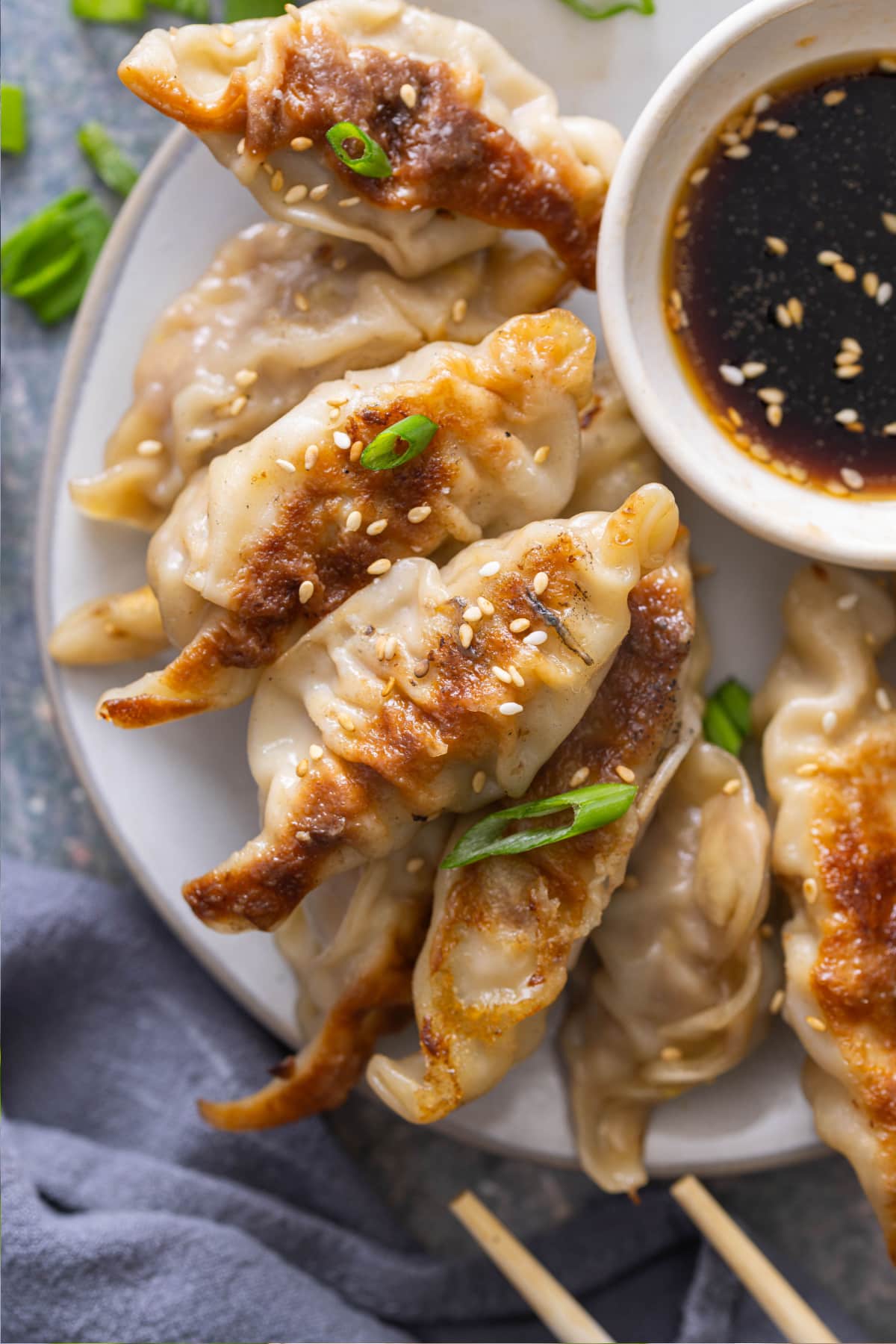 Potstickers plated with dipping sauce