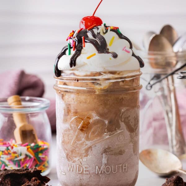 Mason Jar Ice Cream topped with whipped cream and chocolate syrup.