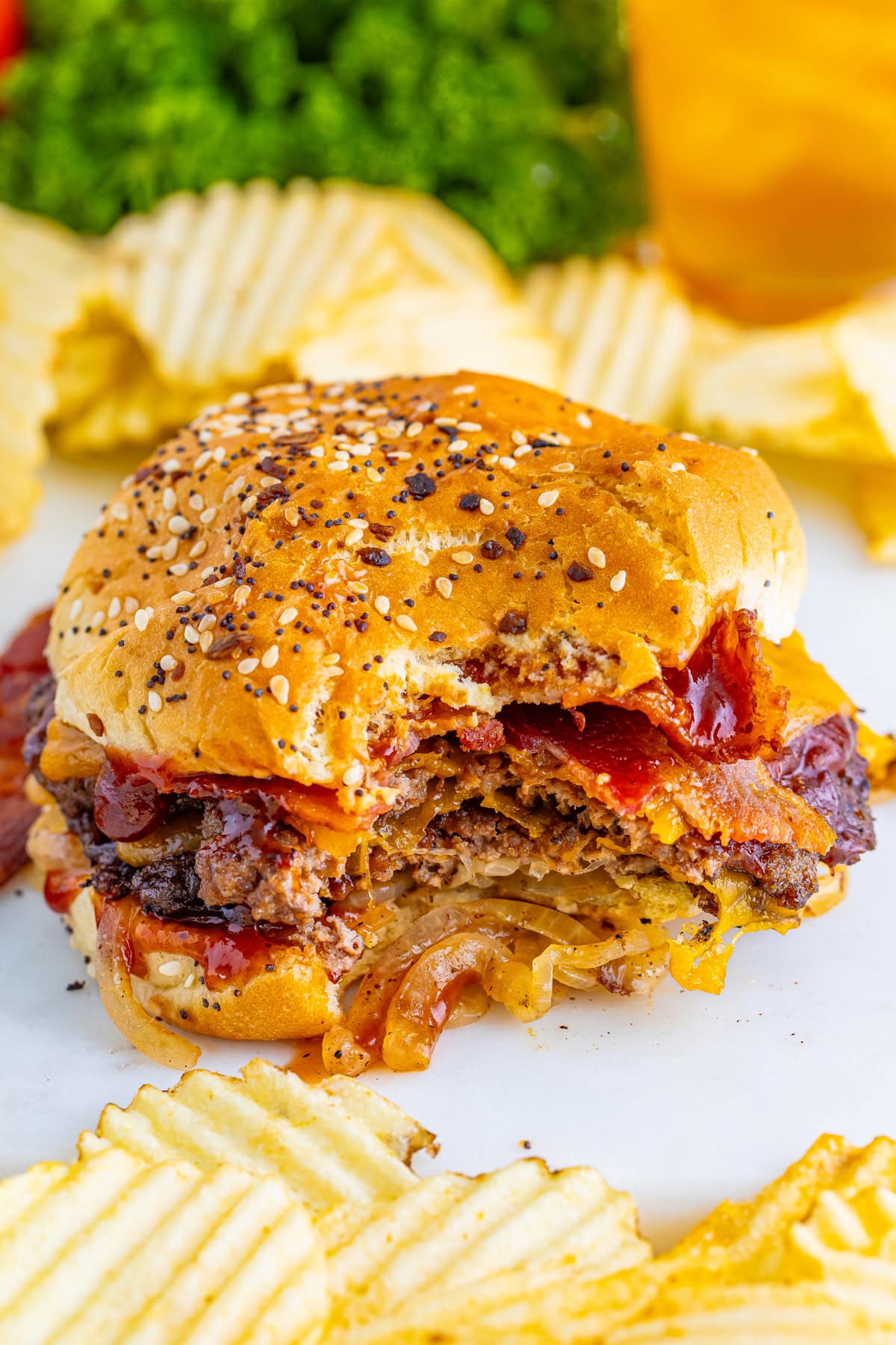 A smash burger on a bun with a few bites missing