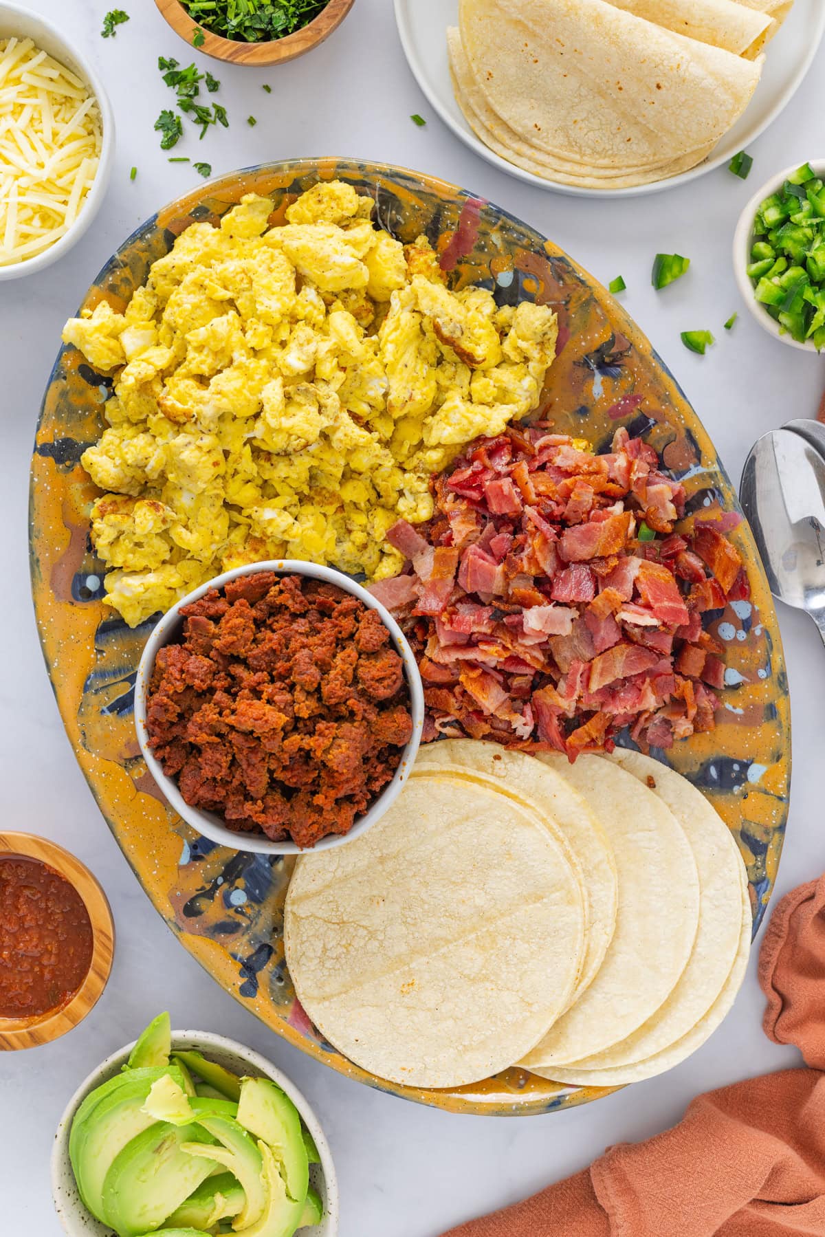 These homemade Breakfast Tacos are savory, cheesy, and everything you could want in a corn tortilla! Serve them for any meal or meal prep so you can enjoy them all week. Breakfast Tacos Charcuterie Board