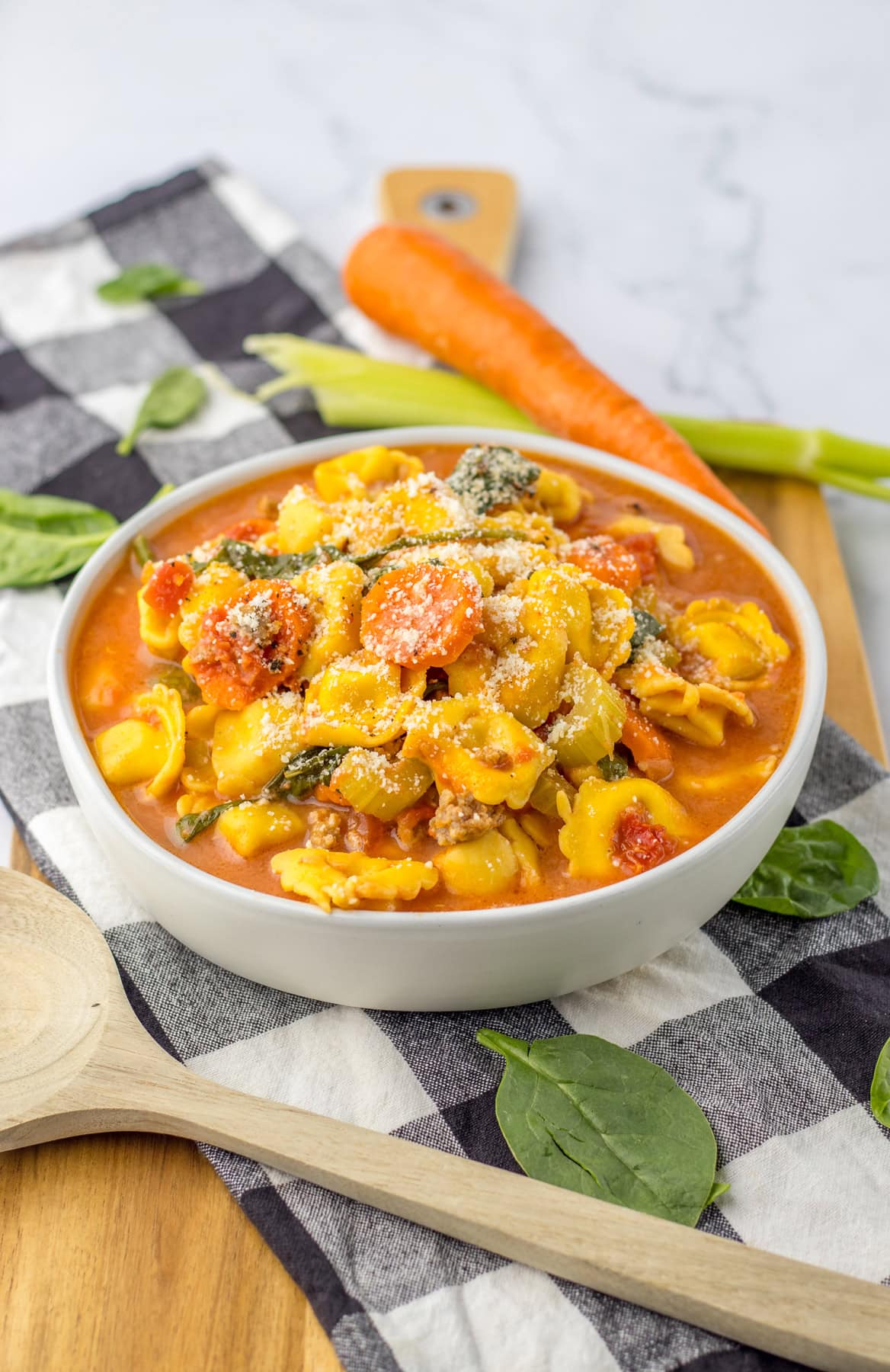This savory and flavorful recipe for Crockpot Tortellini Soup is great any night of the week. It’s a comforting meal that even tastes delicious for lunch the next day. Crockpot Tortellini Soup served in a white bowl.