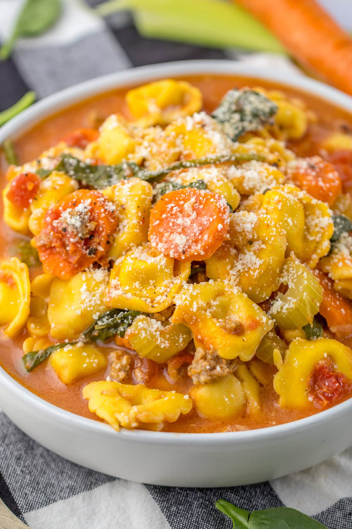 Crockpot Tortellini Soup served in a white bowl.
