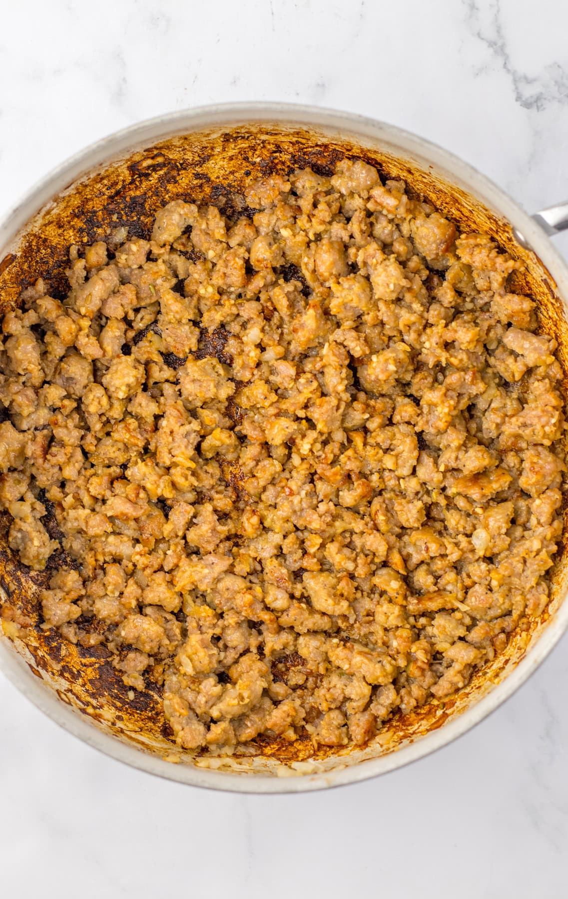 This savory and flavorful recipe for Crockpot Tortellini Soup is great any night of the week. It’s a comforting meal that even tastes delicious for lunch the next day. Browned and cooked sausage and onions in a skillet.