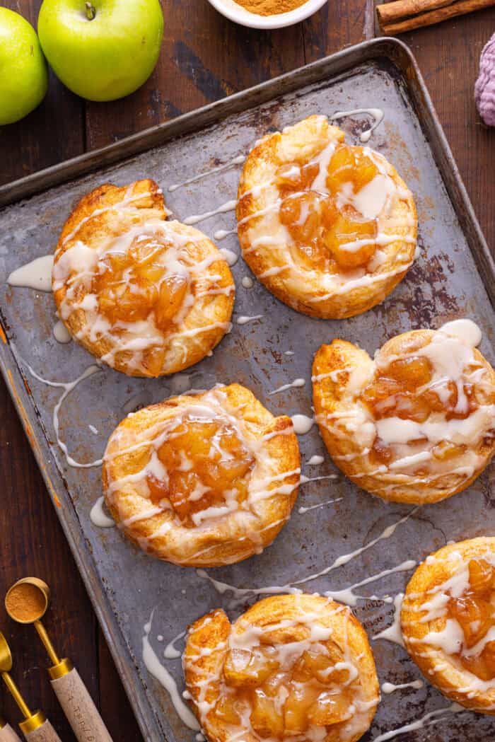 Crescent roll apple danishes on a baking sheet