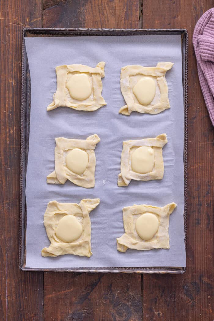 Cream cheese filling on puff pastry squares