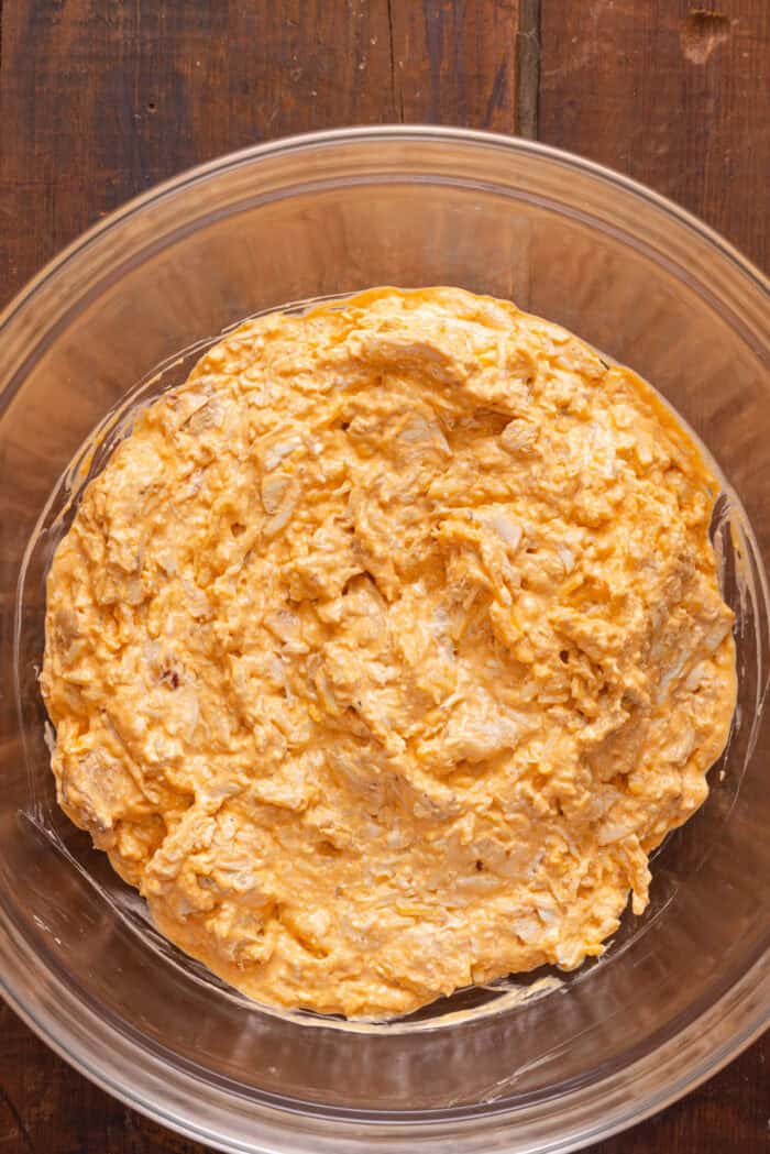 Buffalo chicken dip ingredients mixed together in a bowl