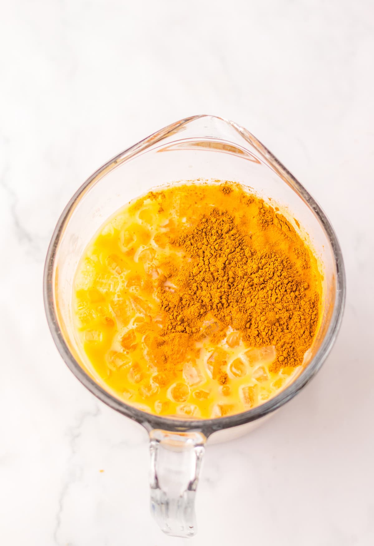 Ingredients for a Pumpkin Spice Frappuccino in a blender.