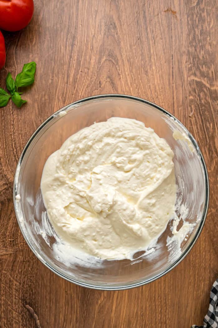 Cream cheese, ricotta, and sour cream combined in a bowl