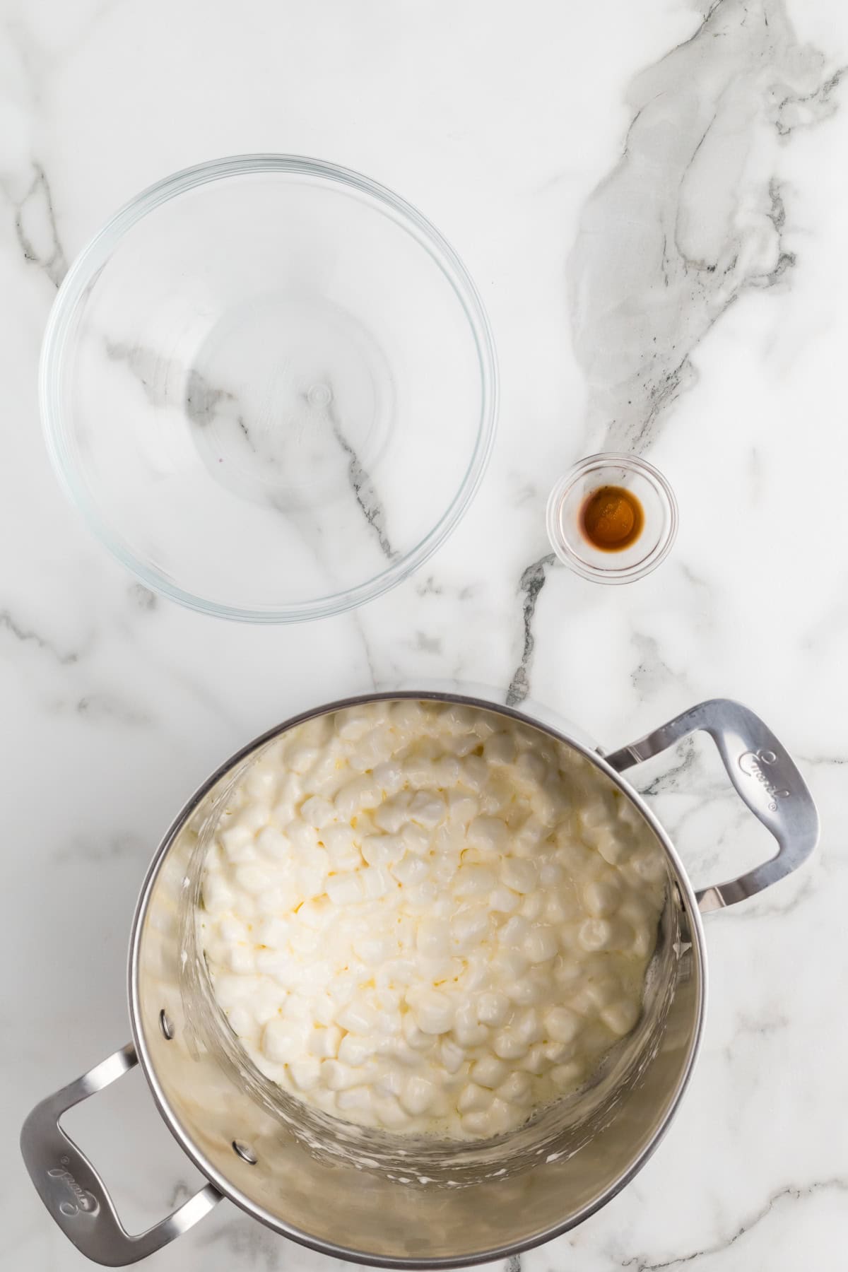 Overhead shot of melted butter and marshmallows combined in a pot as they begin to melt.