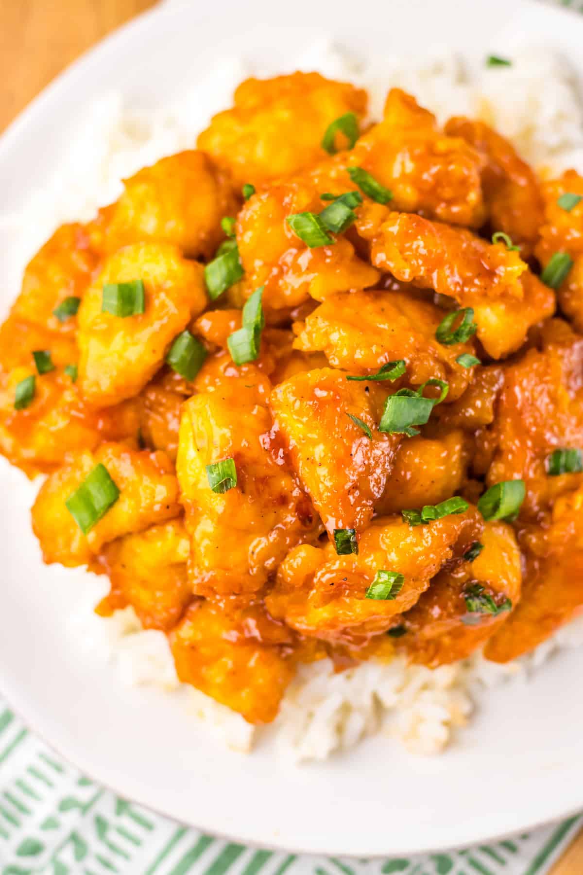 Slow Cooker Hawaiian Chicken served over rise with green onions for garnish