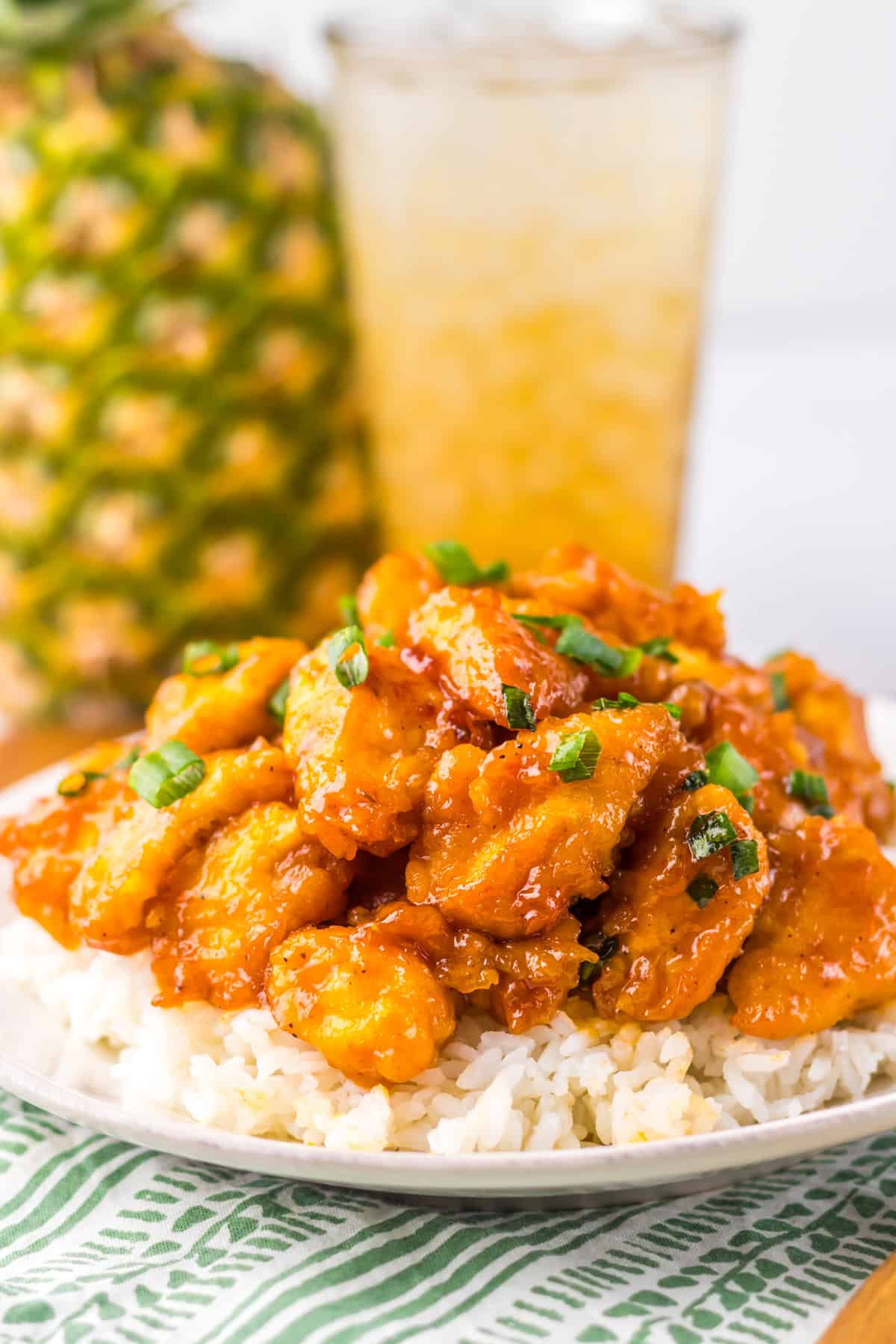 This Slow Cooker Hawaiian Chicken recipe is an easy and delicious dinner option. Slow Cooker Hawaiian Chicken on white plate with rice and glass of tea