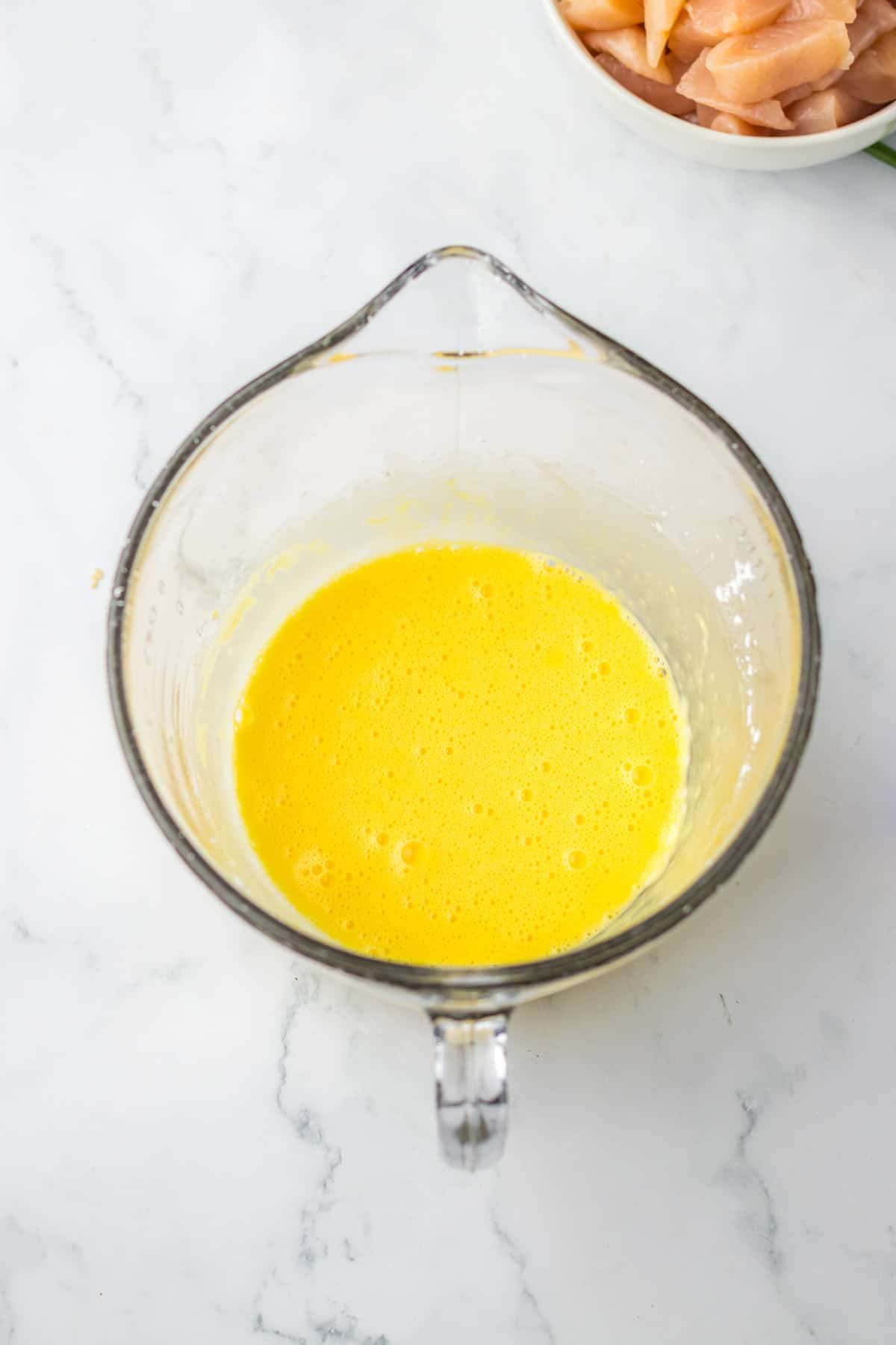 eggs and cornstarch whisked together in glass measuring cup