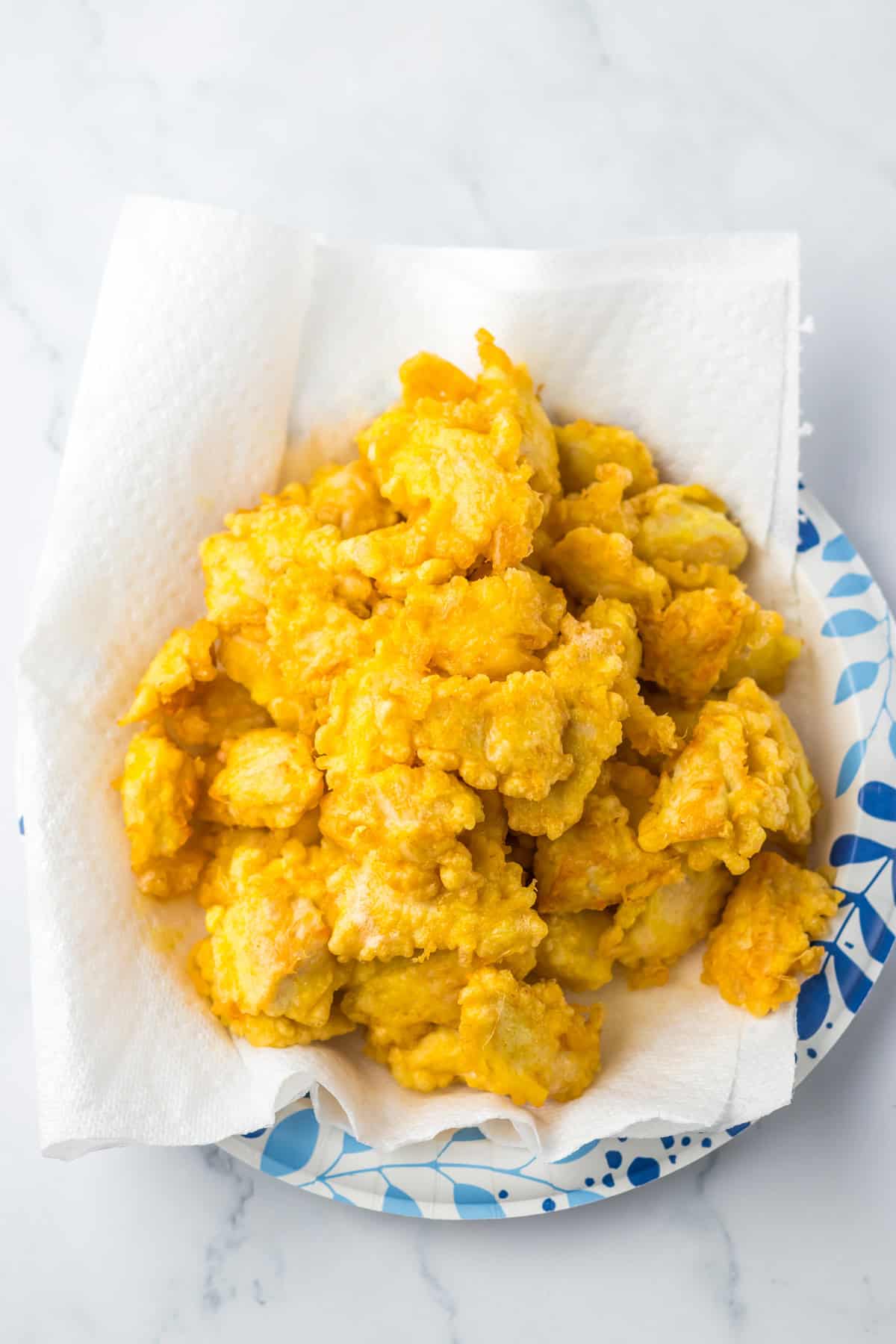 fried chicken pieces on paper plate with paper towel