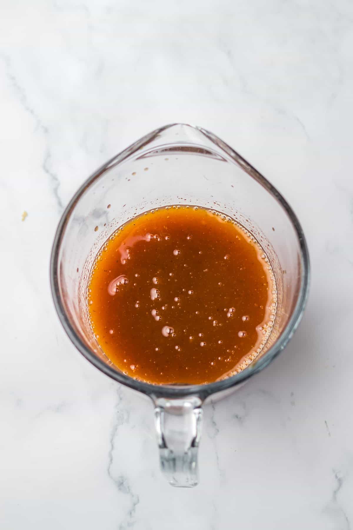 sauce for Slow Cooker Hawaiian Chicken in glass measuring cup