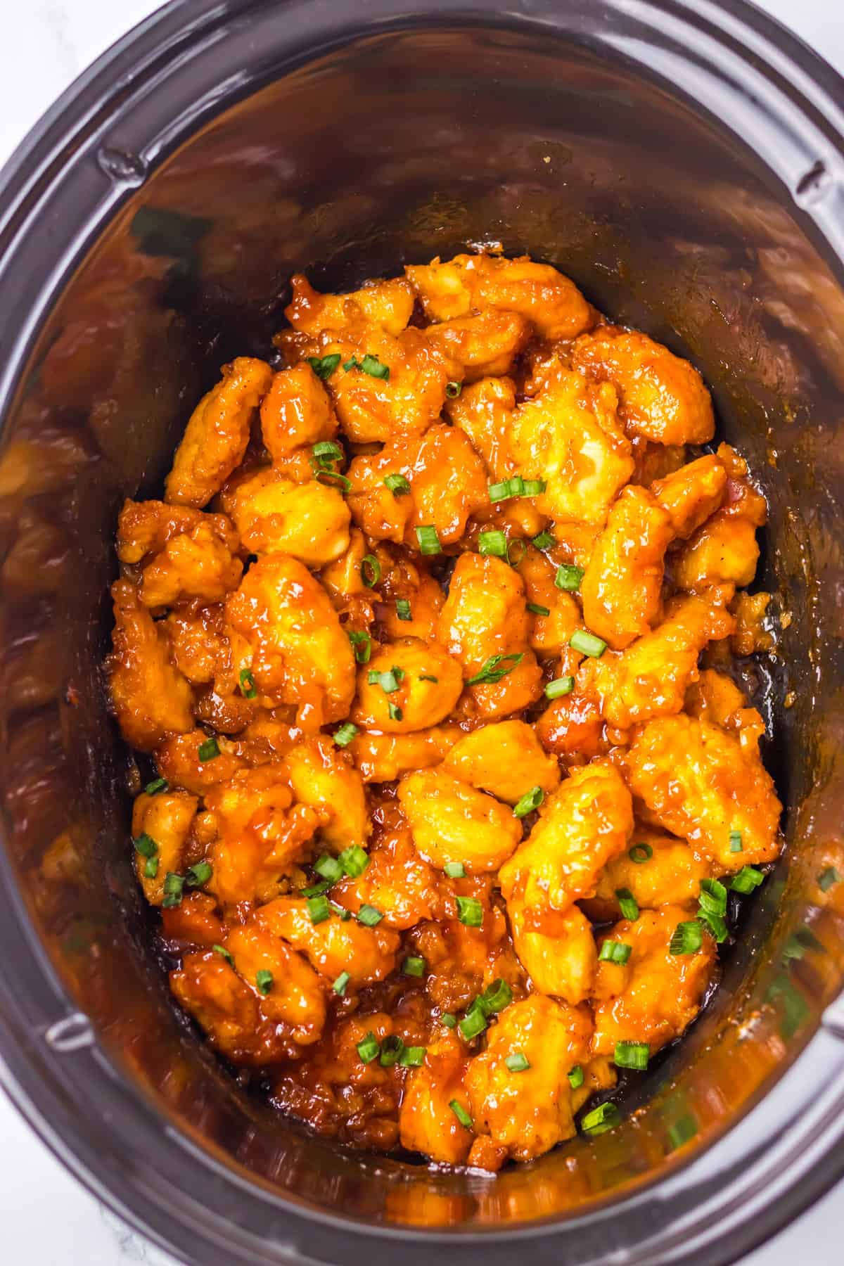 Slow Cooker Hawaiian Chicken cooked with green onions for garnish