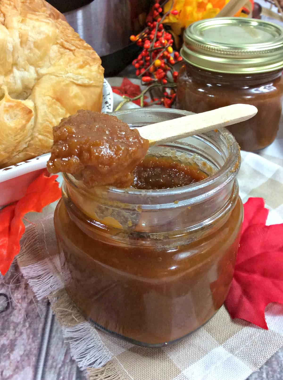 If you're looking for a seasonal treat that’s bursting with flavor, this Instant Pot Sweet Potato Butter is a must-try! Creamy, sweet, and perfectly spiced, this spread is amazing on anything from freshly baked croissants to cinnamon raisin toast (trust me, it’s a game-changer!). Whether you’re hosting a cozy brunch, prepping for holiday gifts, or just want something special to enjoy with breakfast, this recipe has you covered. A close-up view of Sweet Potato Butter in a jar, ready to be served alongside freshly baked bread.