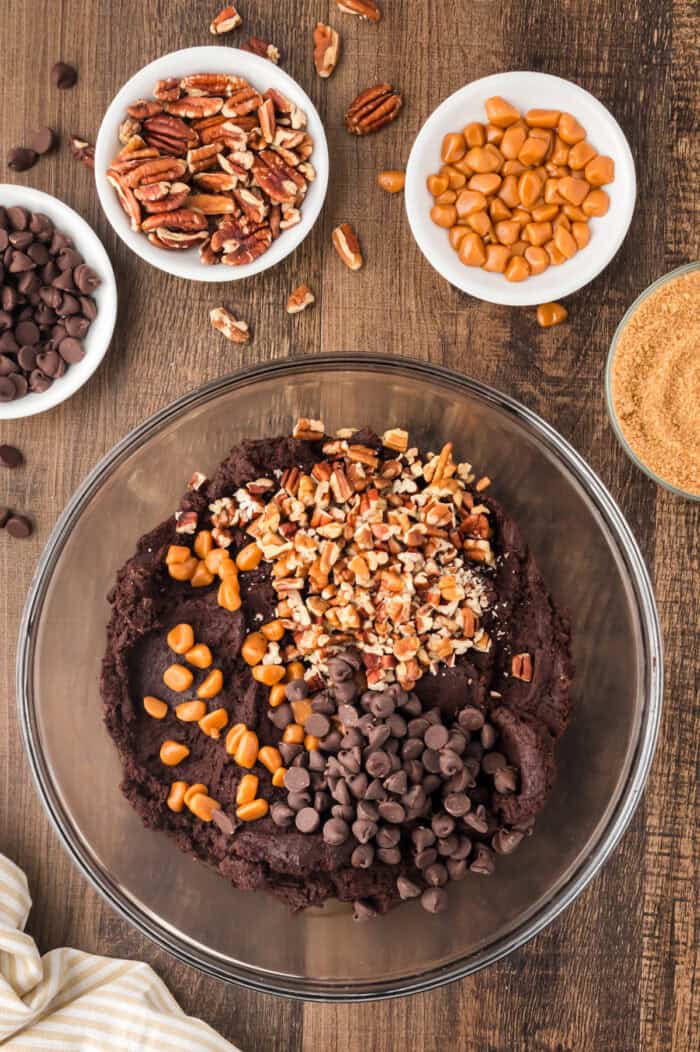 Chocolate chips, caramel, and pecans added to cookie dough batter