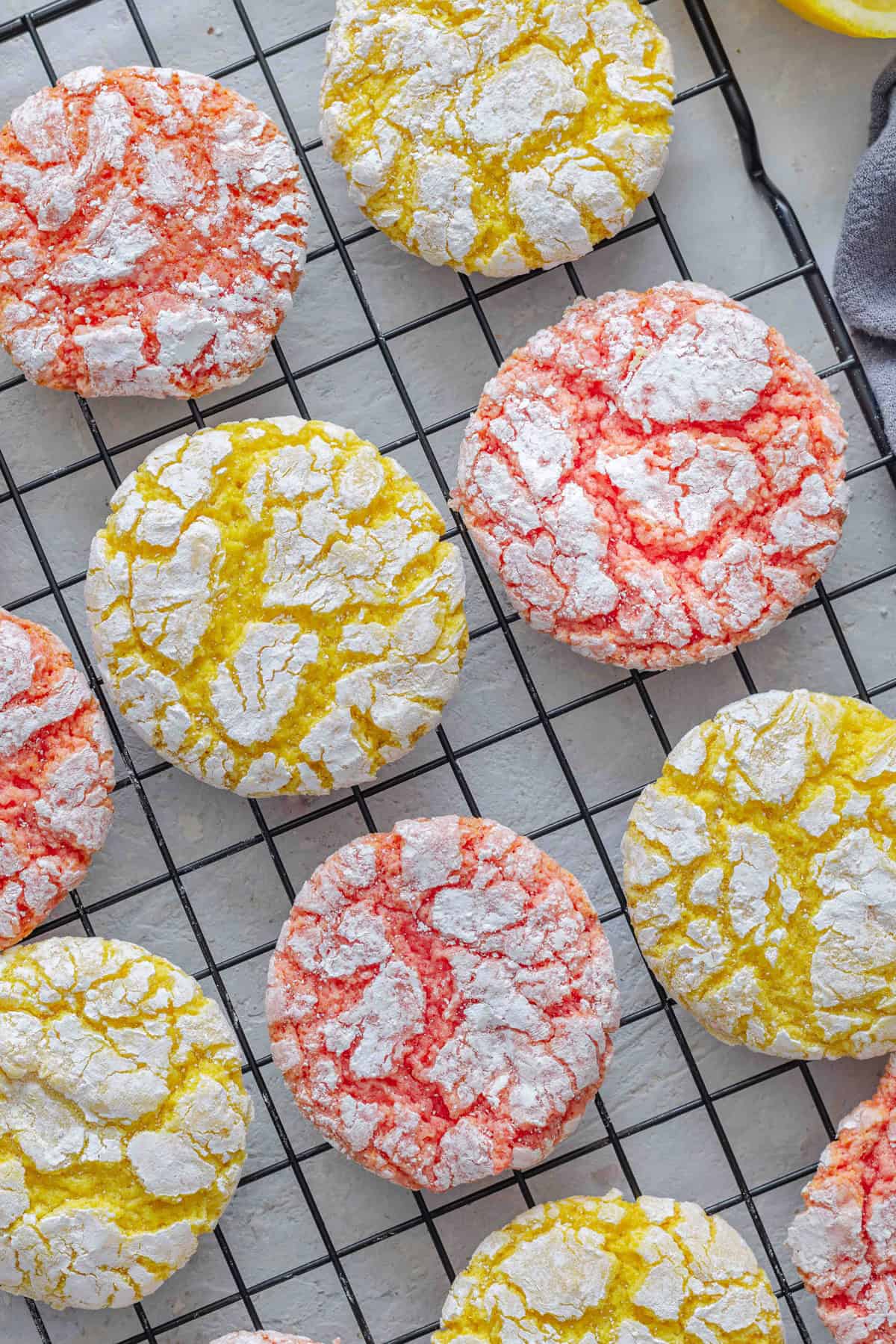 Overhead view of lemon and strawberry Cool Whip cake mix cookies on a cooling rack