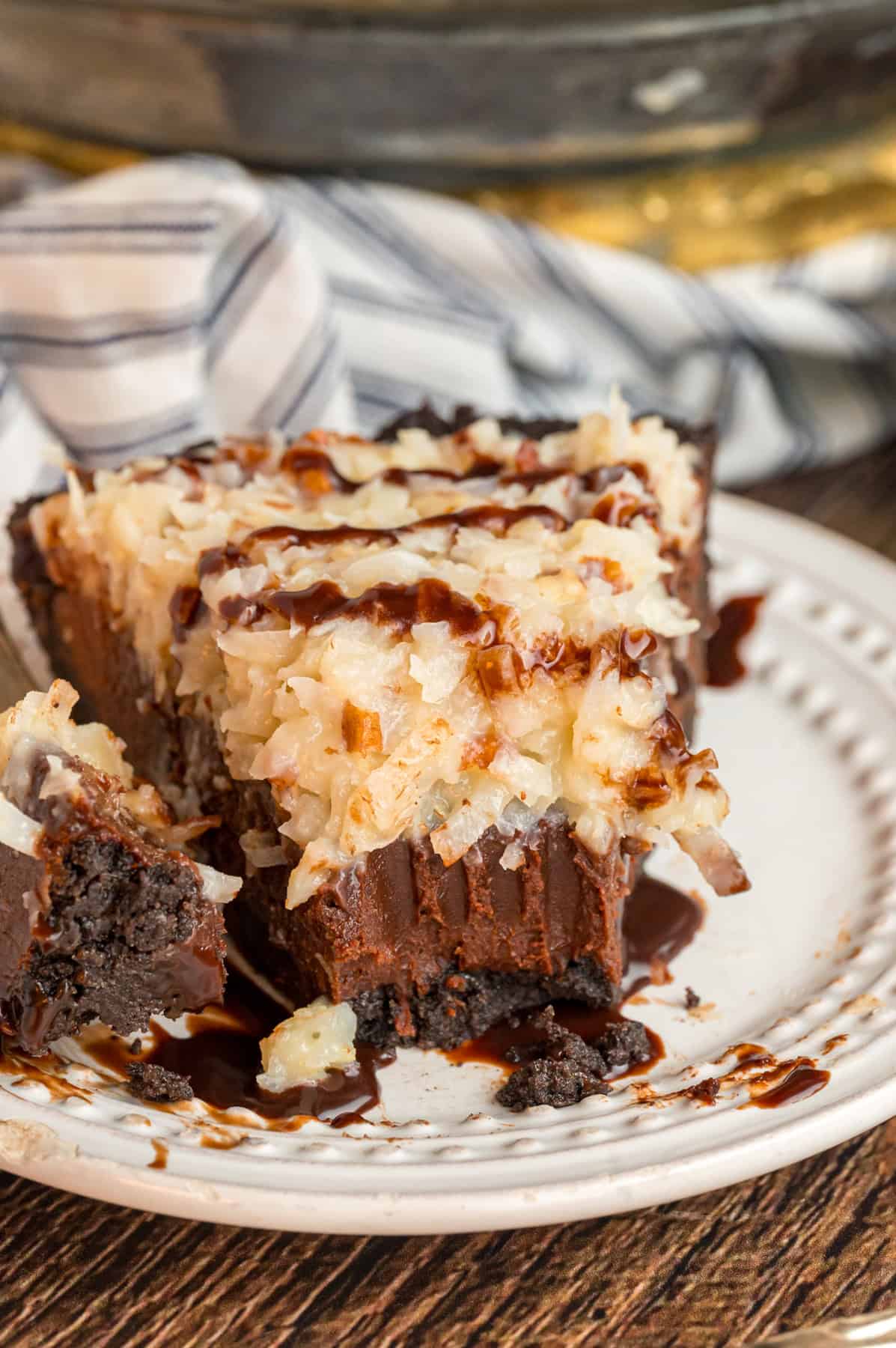 A slice of German chocolate pie with a bite missing