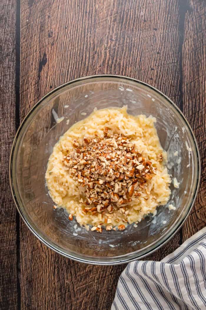 Pecans added to the coconut topping in a bowl