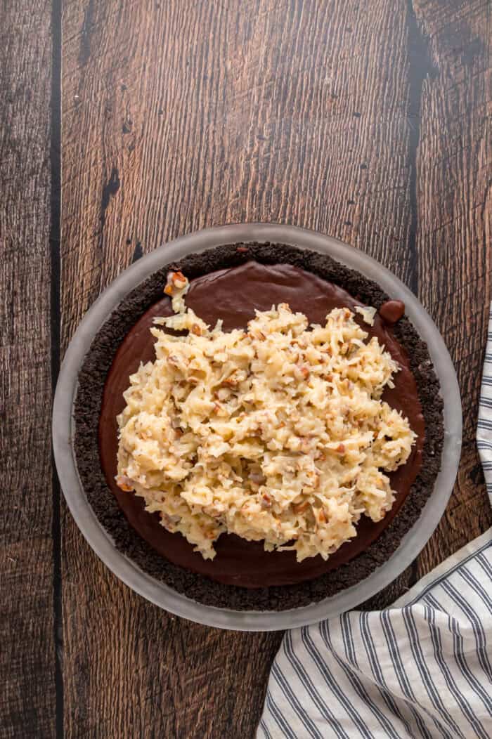 Coconut topping on top of chocolate filling in an Oreo crust