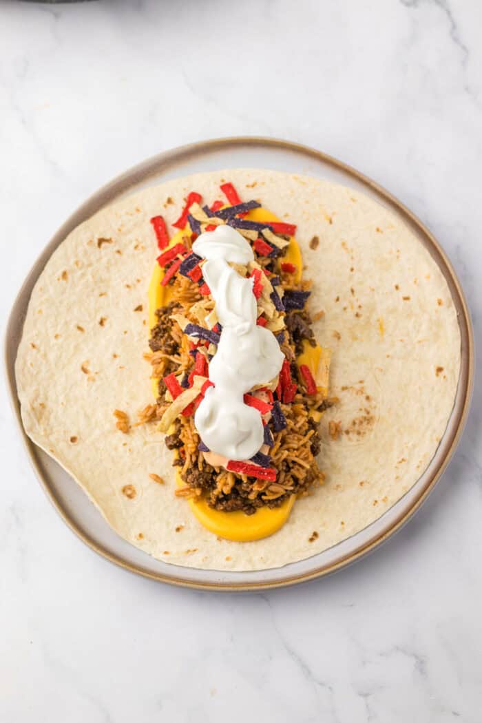Burrito ingredients layered on a tortilla